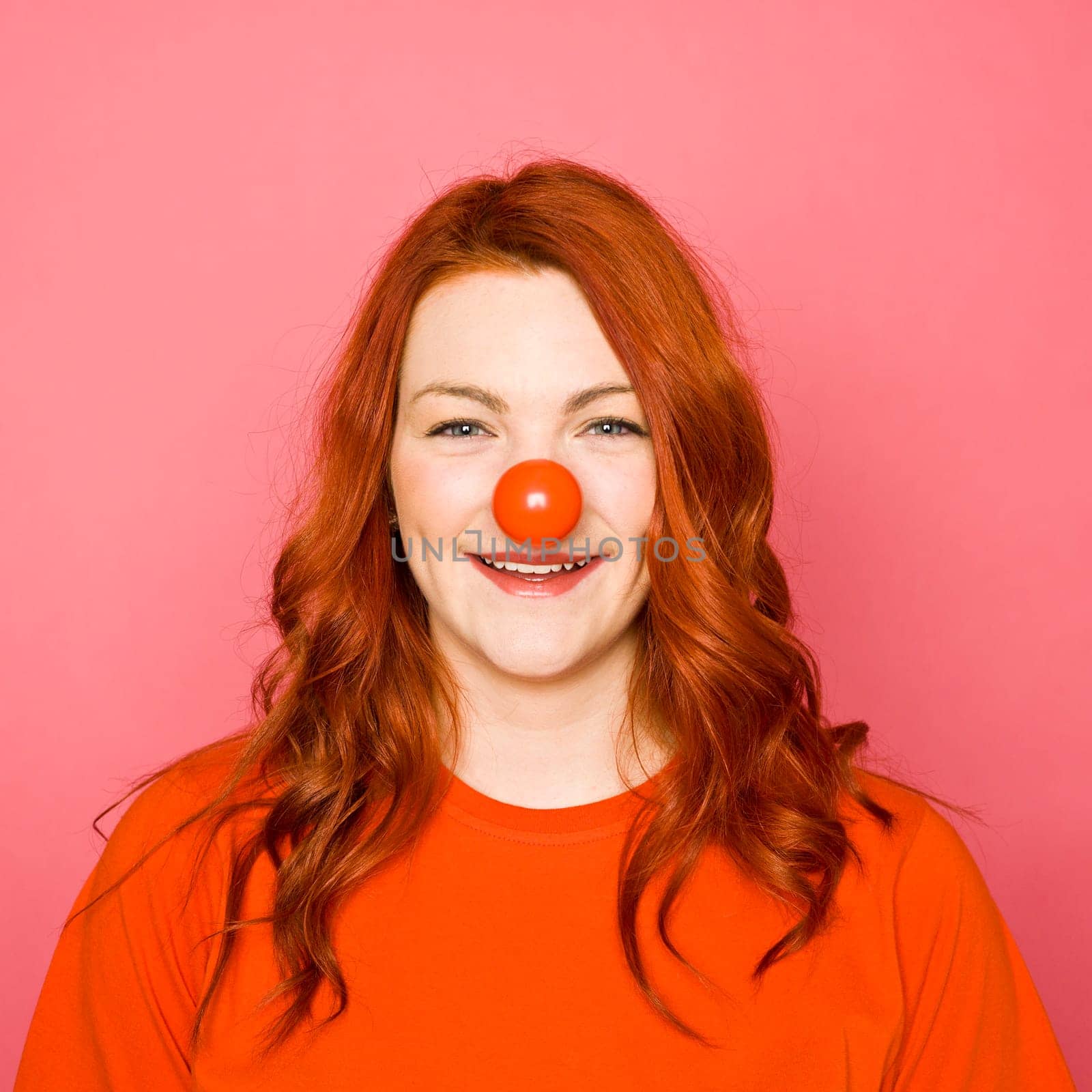 Woman with red hair on pink background
