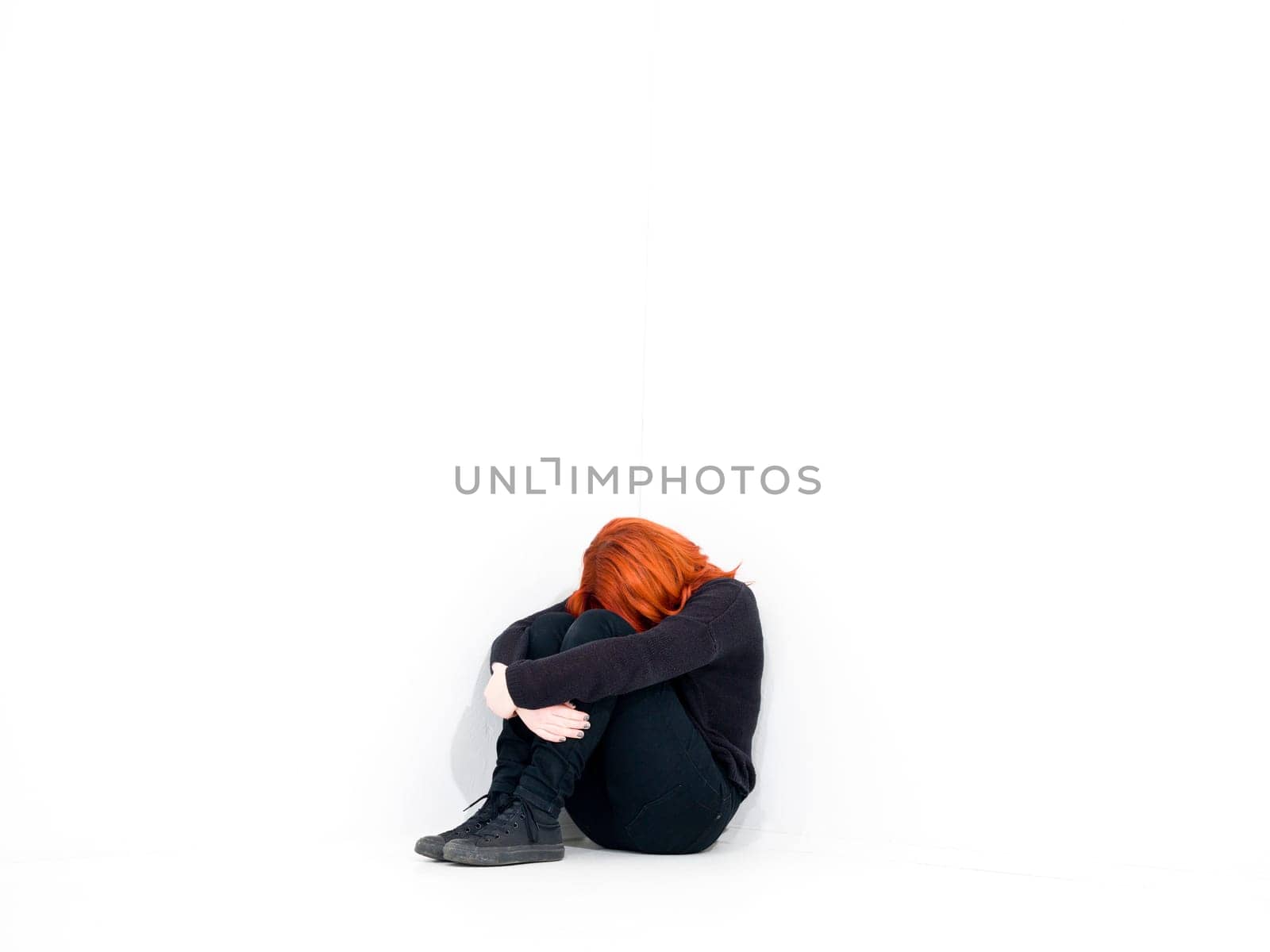 Sad woman in a white room