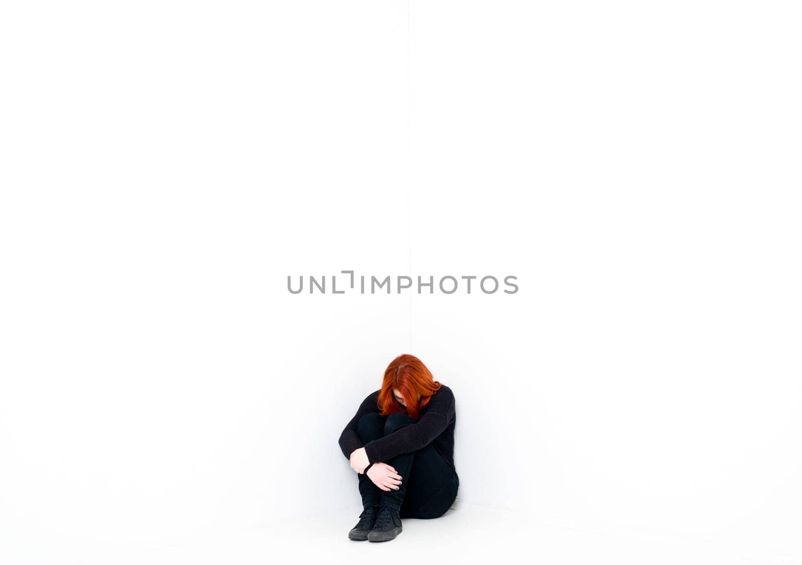Sad woman in a white room