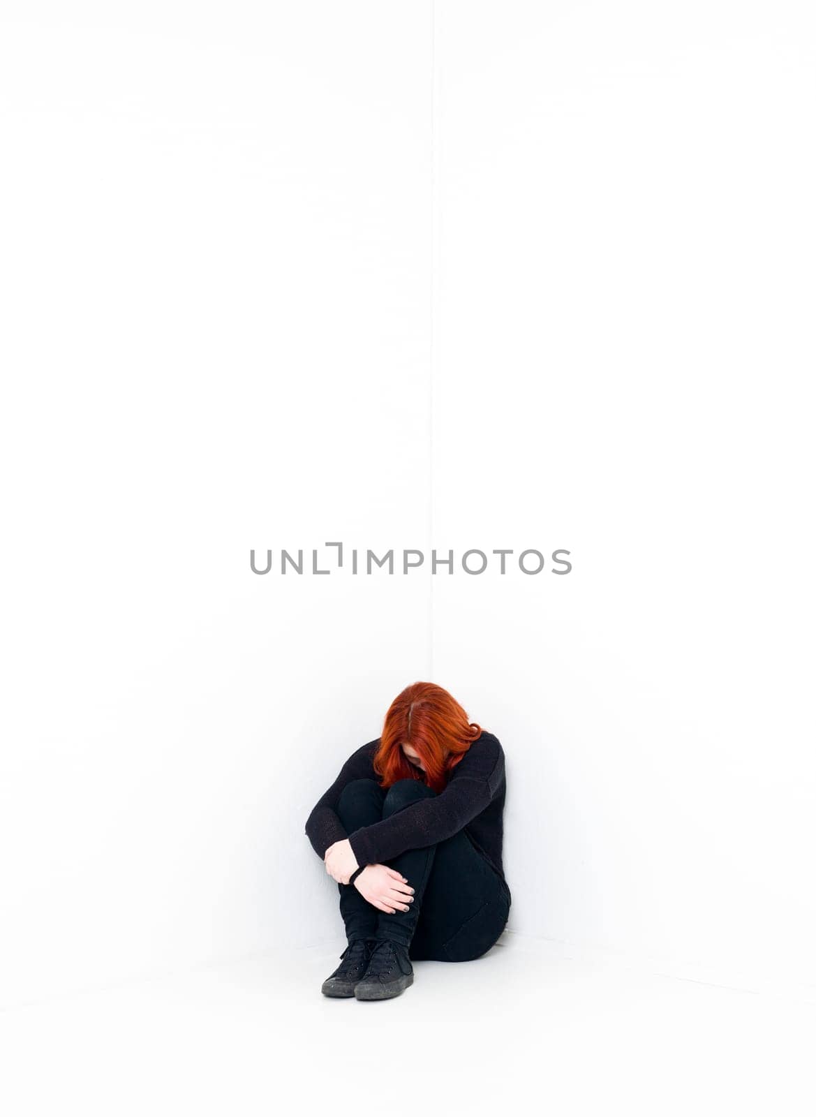 Sad woman in a white room