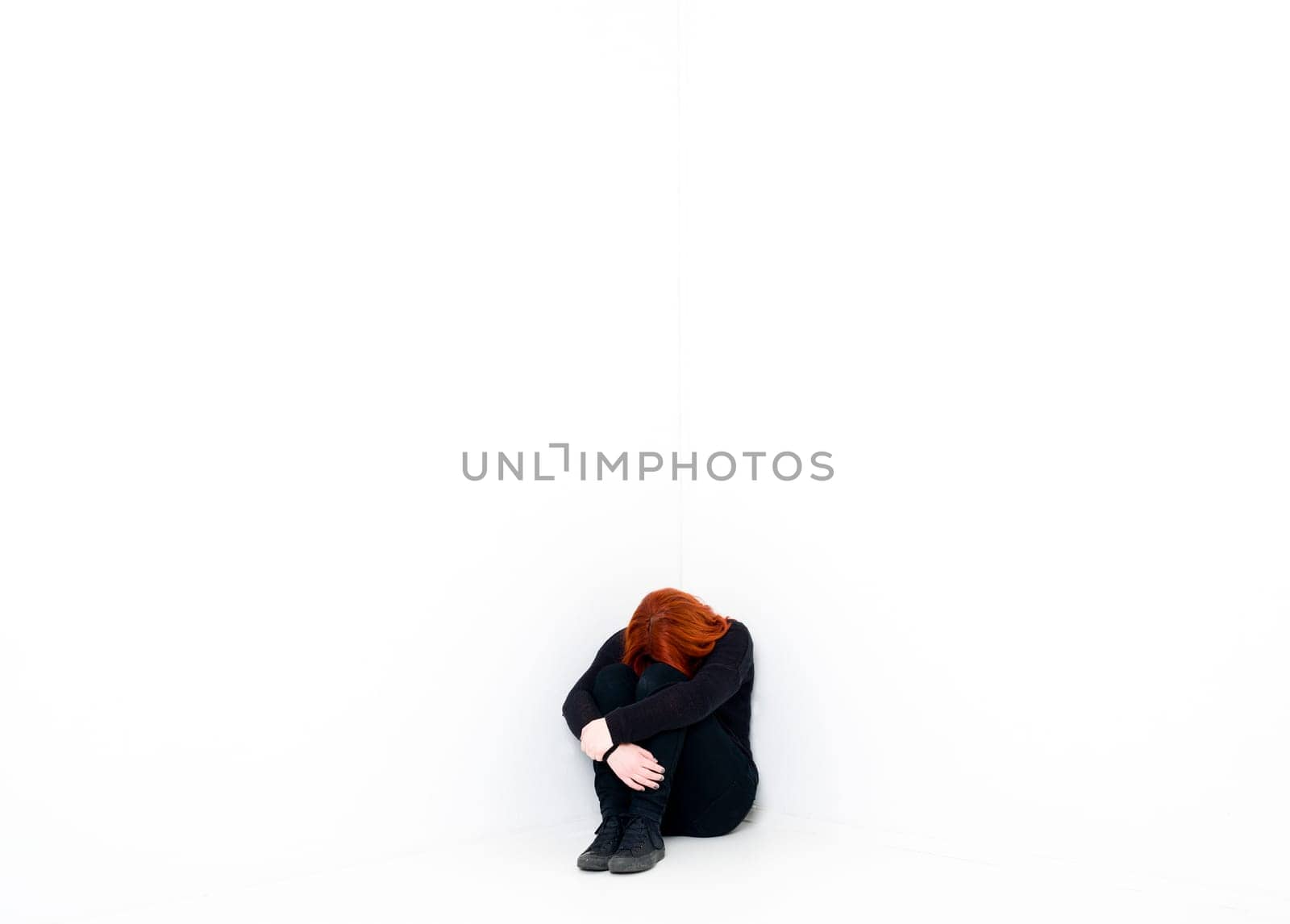 Sad woman in a white room