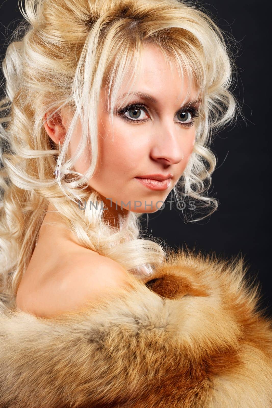 Portrait of a young attractive woman in a fox fur boa.