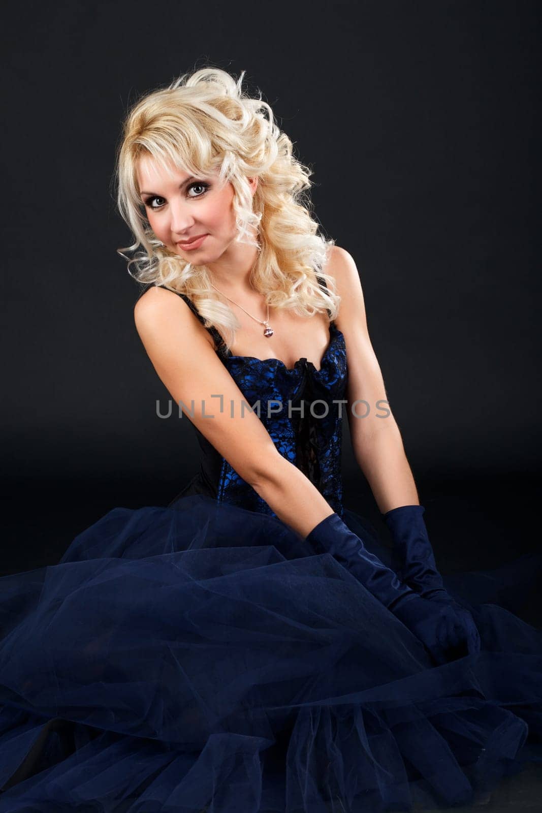Portrait of a young attractive woman in a blue evening dress.