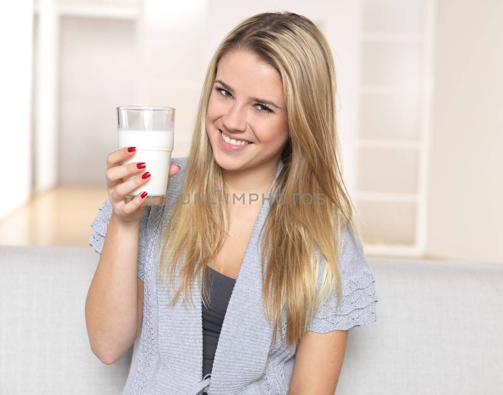 Young woman with glass of milk