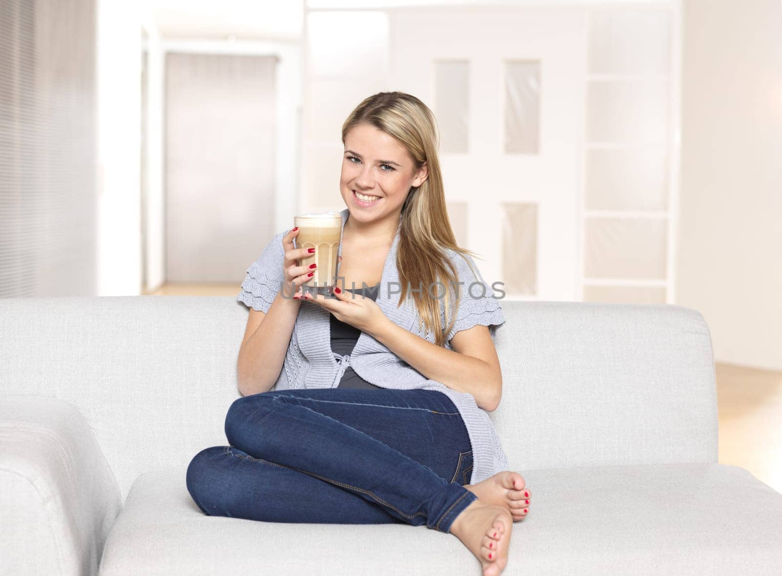 Young woman drinking latte macciato