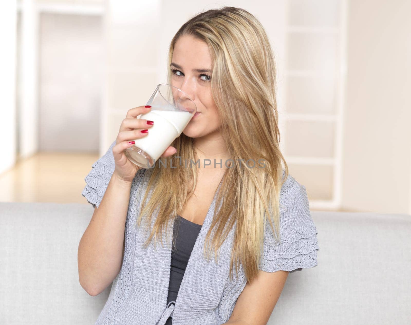 Young woman drinking glass of milk