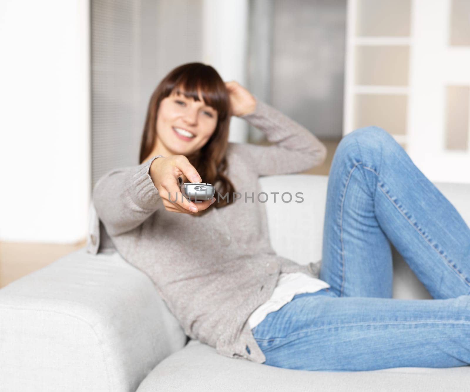 Young woman with remote control