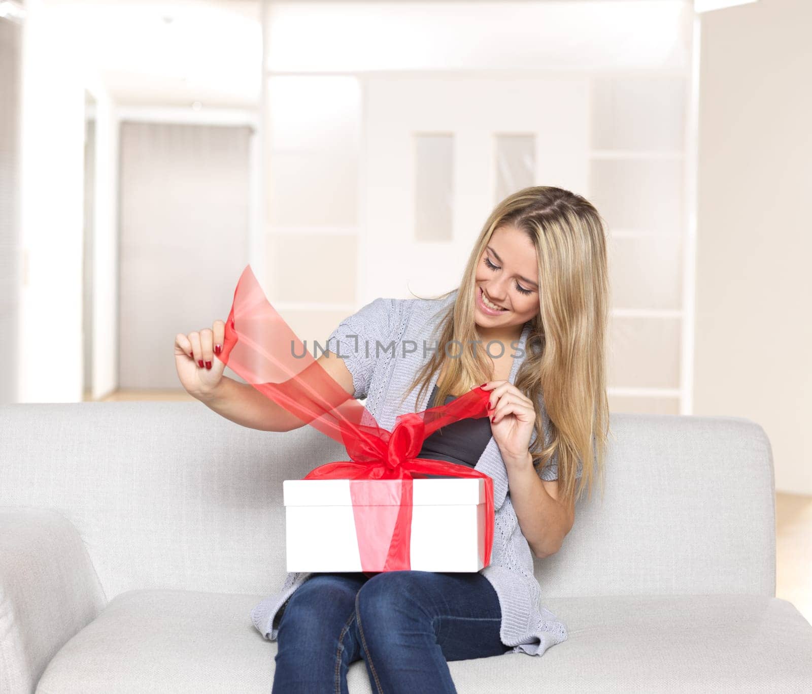 Young woman unwrapping gift