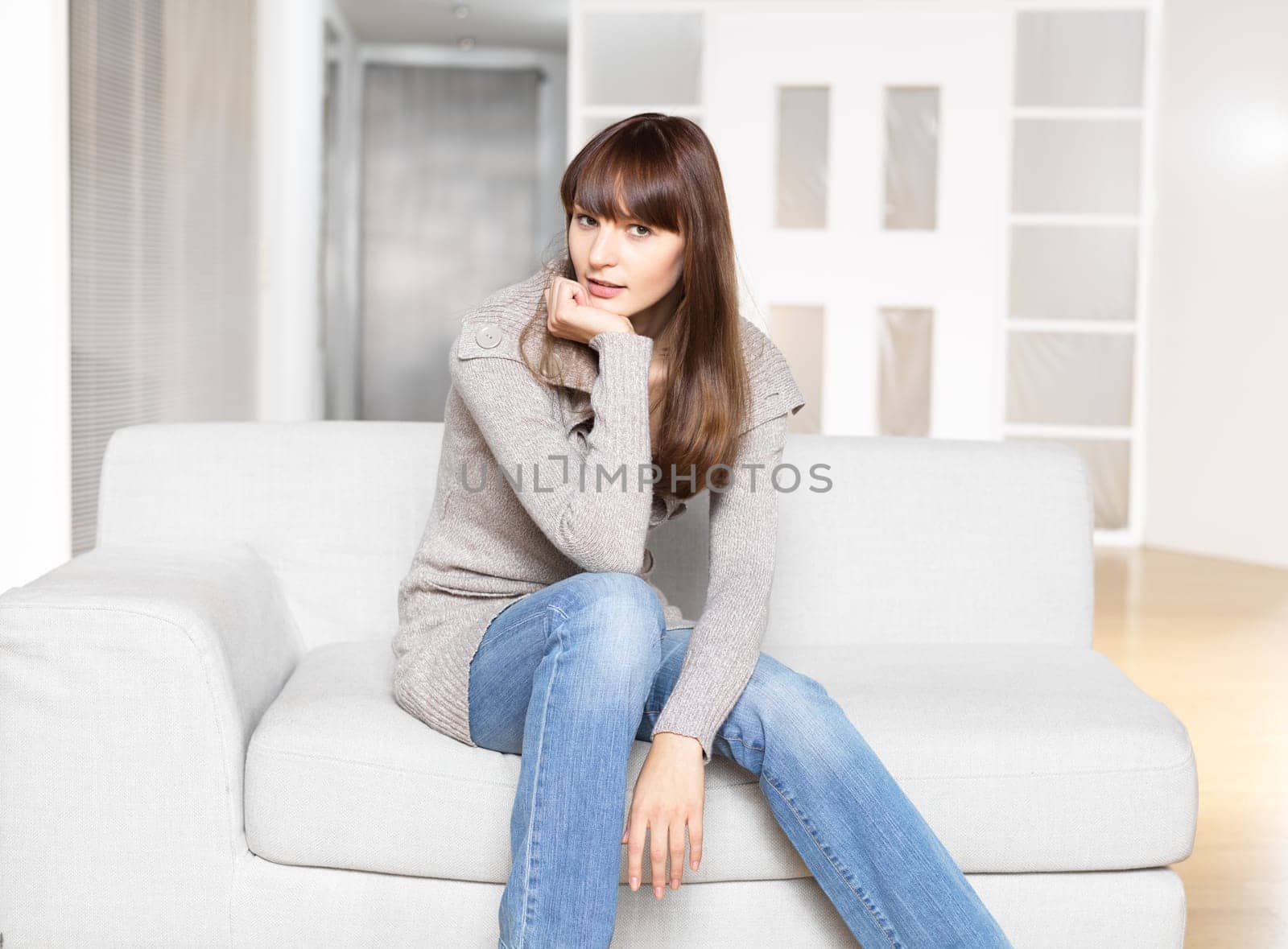Young woman sitting on sofa