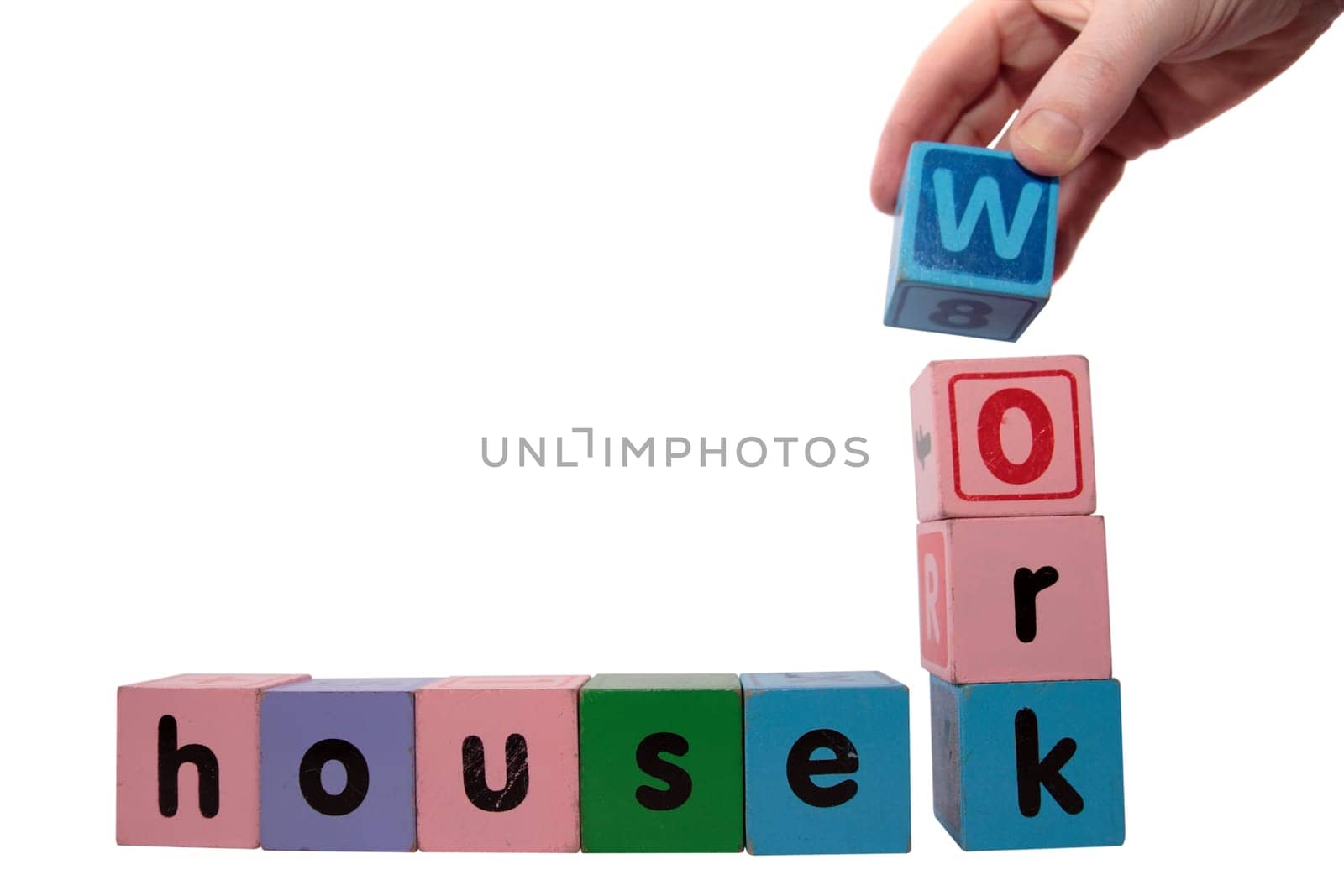 toy letters that spell housework against a white background with clipping path with hand