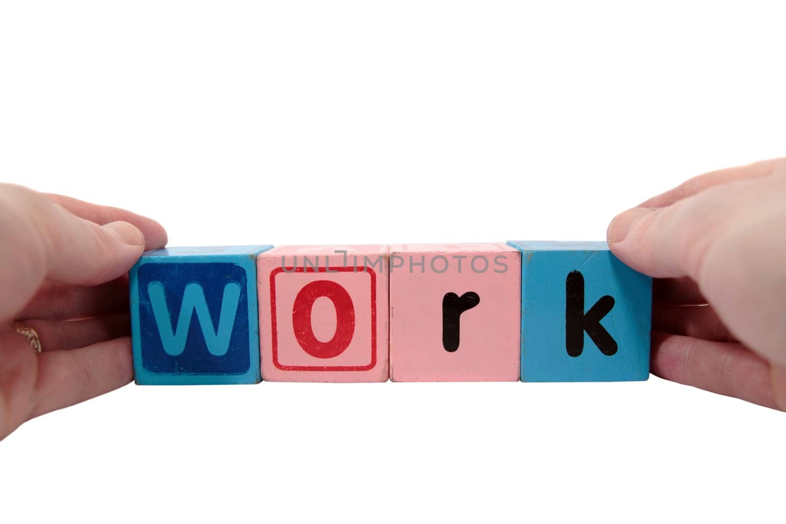 toy letters that spell work held with hands against a white background with clipping path