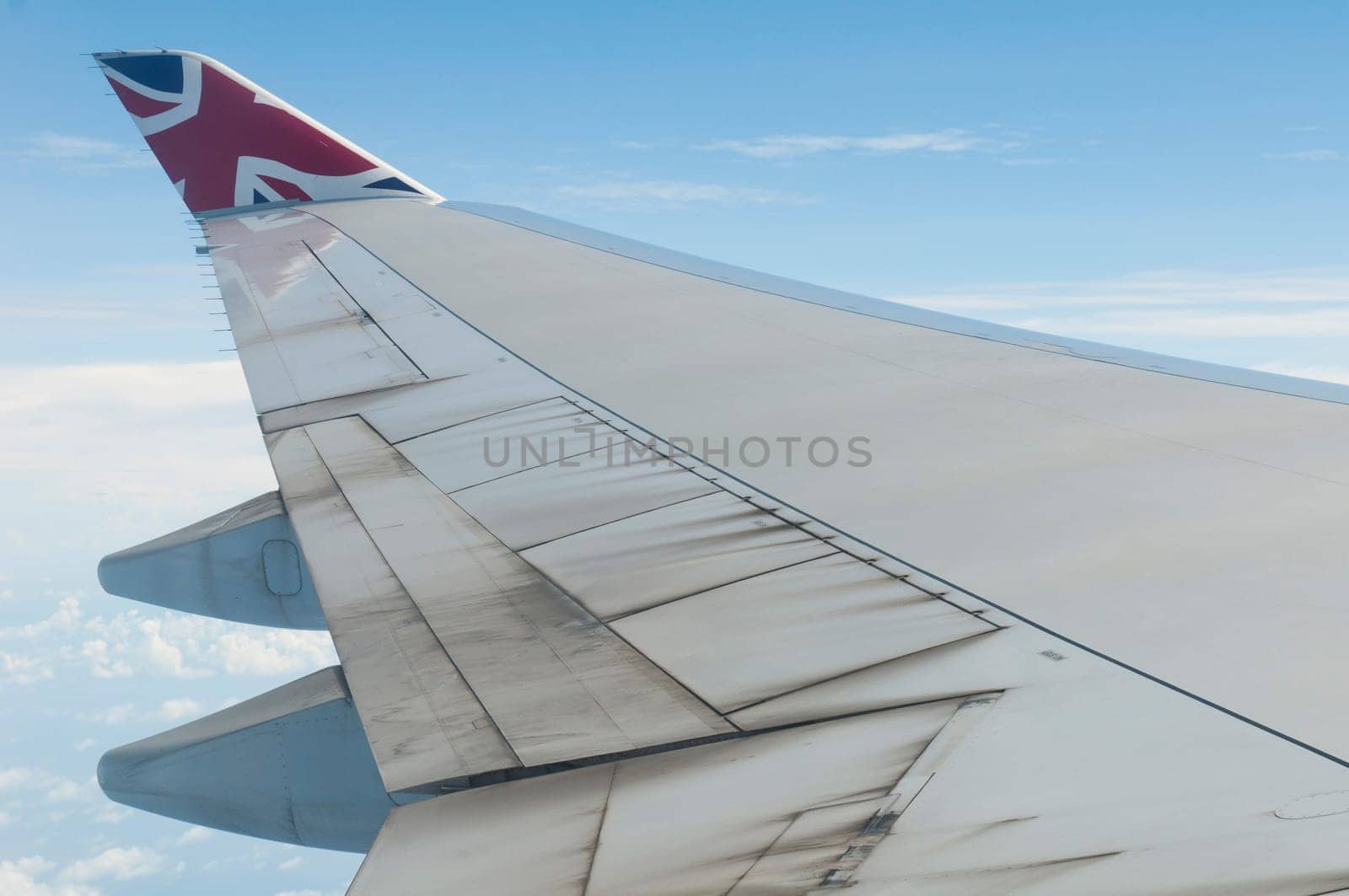 ST JOHNS, ANTIGUA - AUGUST 17: view of Boeing 747 wing of Virgin Atlantic Airways with blue sky clouds close to V. C. Bird International Airport in Antigua on August 17, 2011 in St. John&#039 s, Antigua