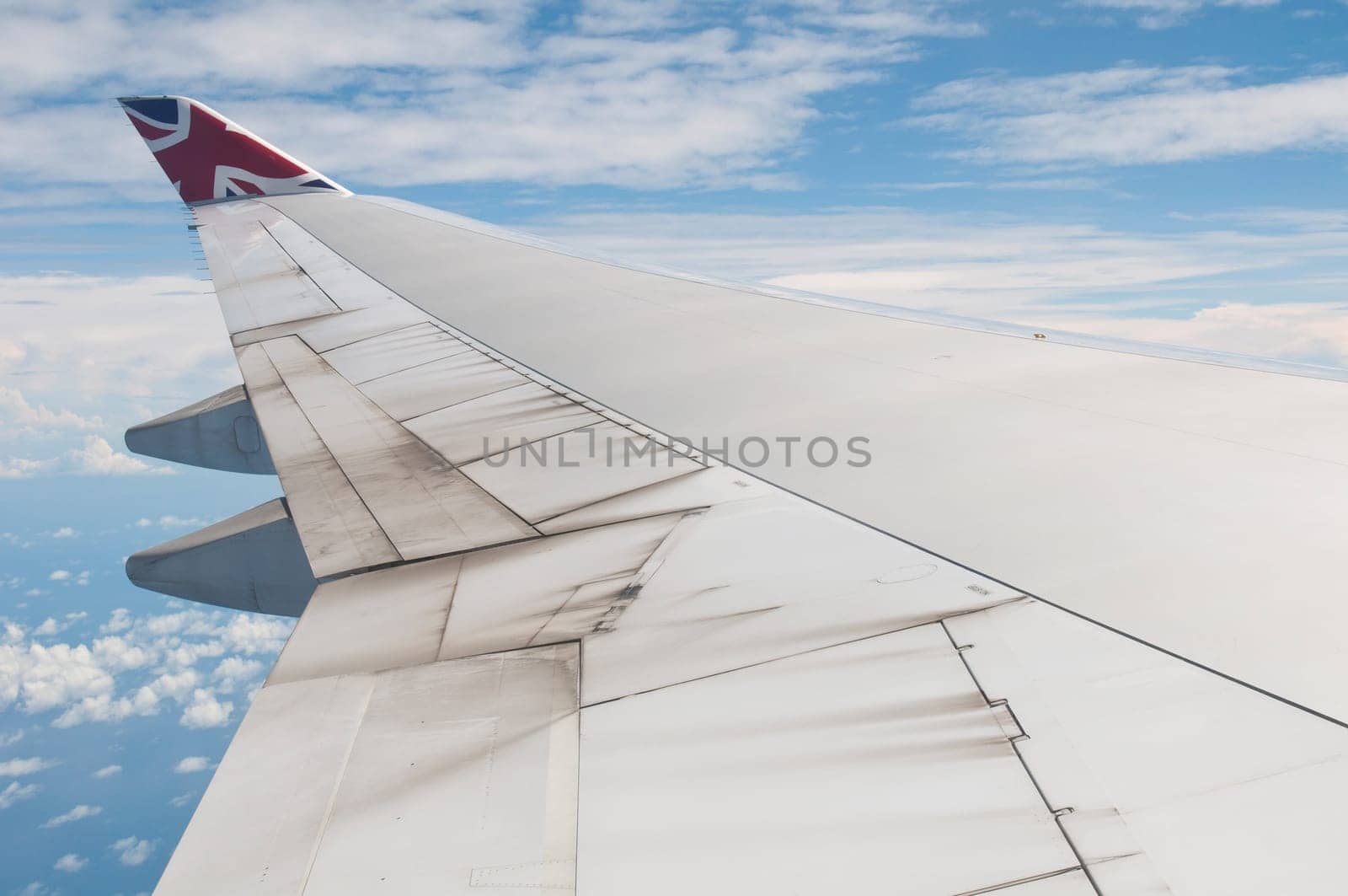 ST JOHNS, ANTIGUA - AUGUST 17: view of Boeing 747 wing of Virgin Atlantic Airways with blue sky clouds close to V. C. Bird International Airport in Antigua on August 17, 2011 in St. John&#039 s, Antigua