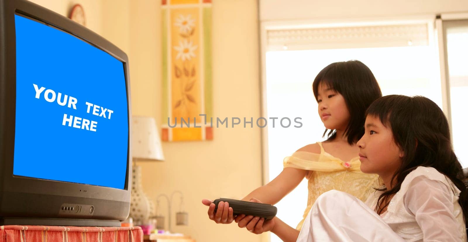 two asian girls dressed as princess, tv remote control, blue copy space