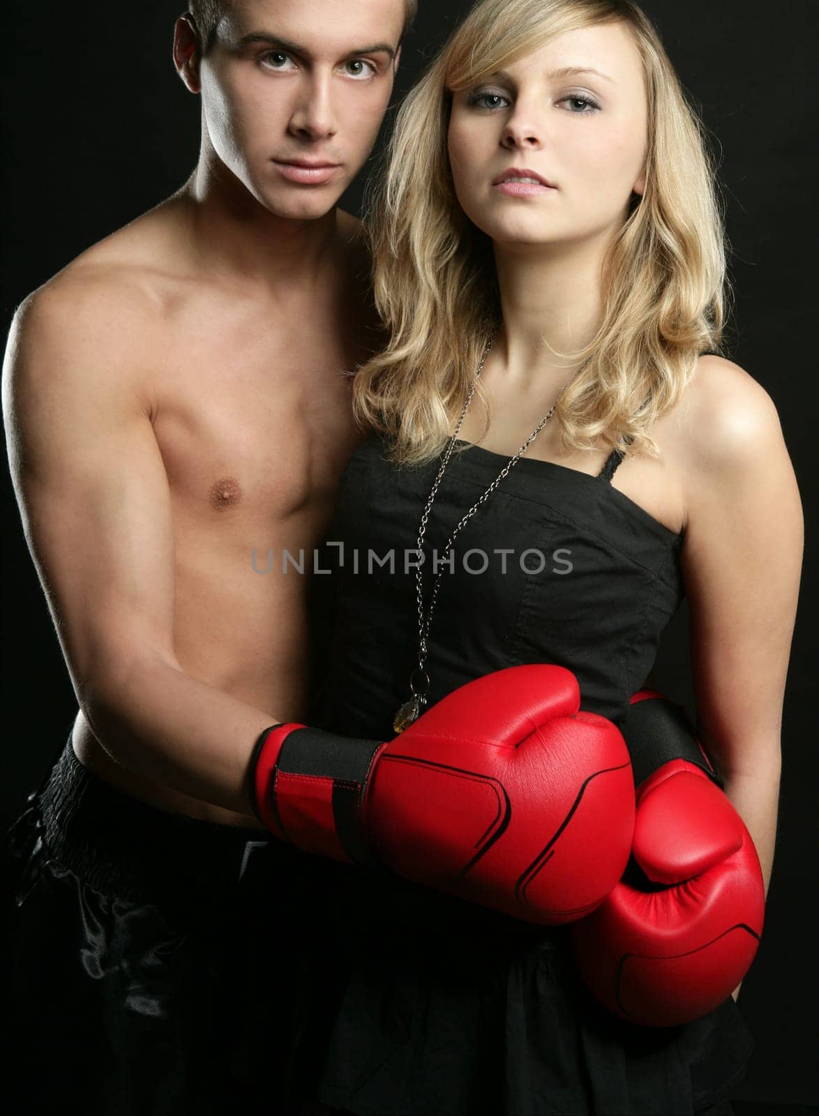 Young beautiful couple of blond girl and handsome boxer man