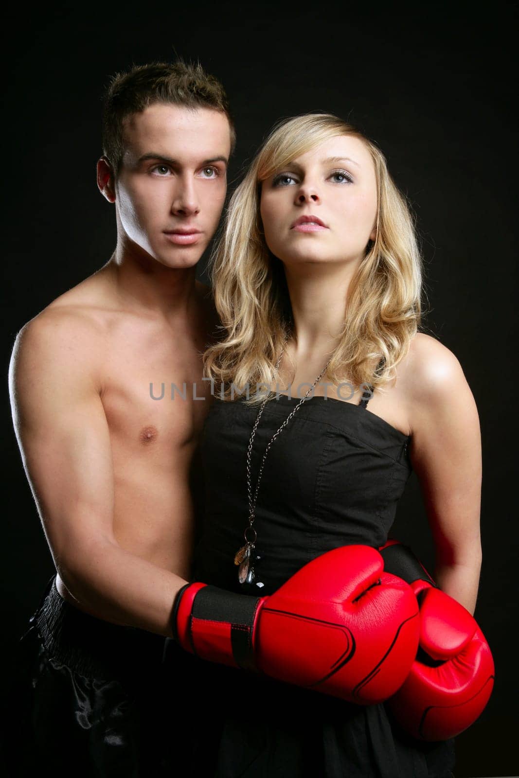 Sexy young male boxer with blond beautiful girl, isolated on black studio shot
