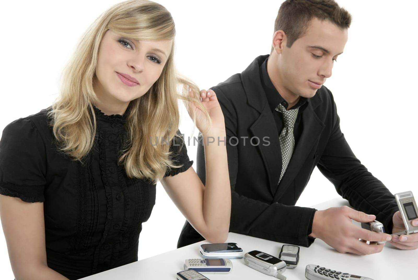 Business couple with many mobile telephones, isolated over white