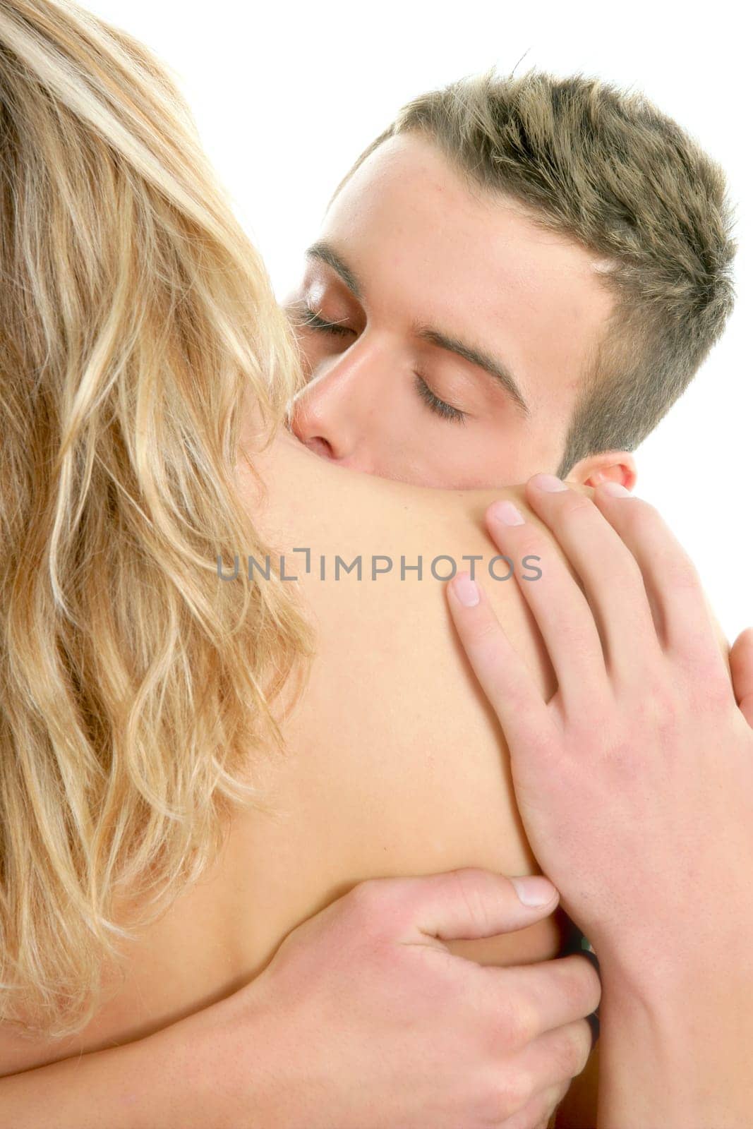 Couple natural kiss close up portrait over white background