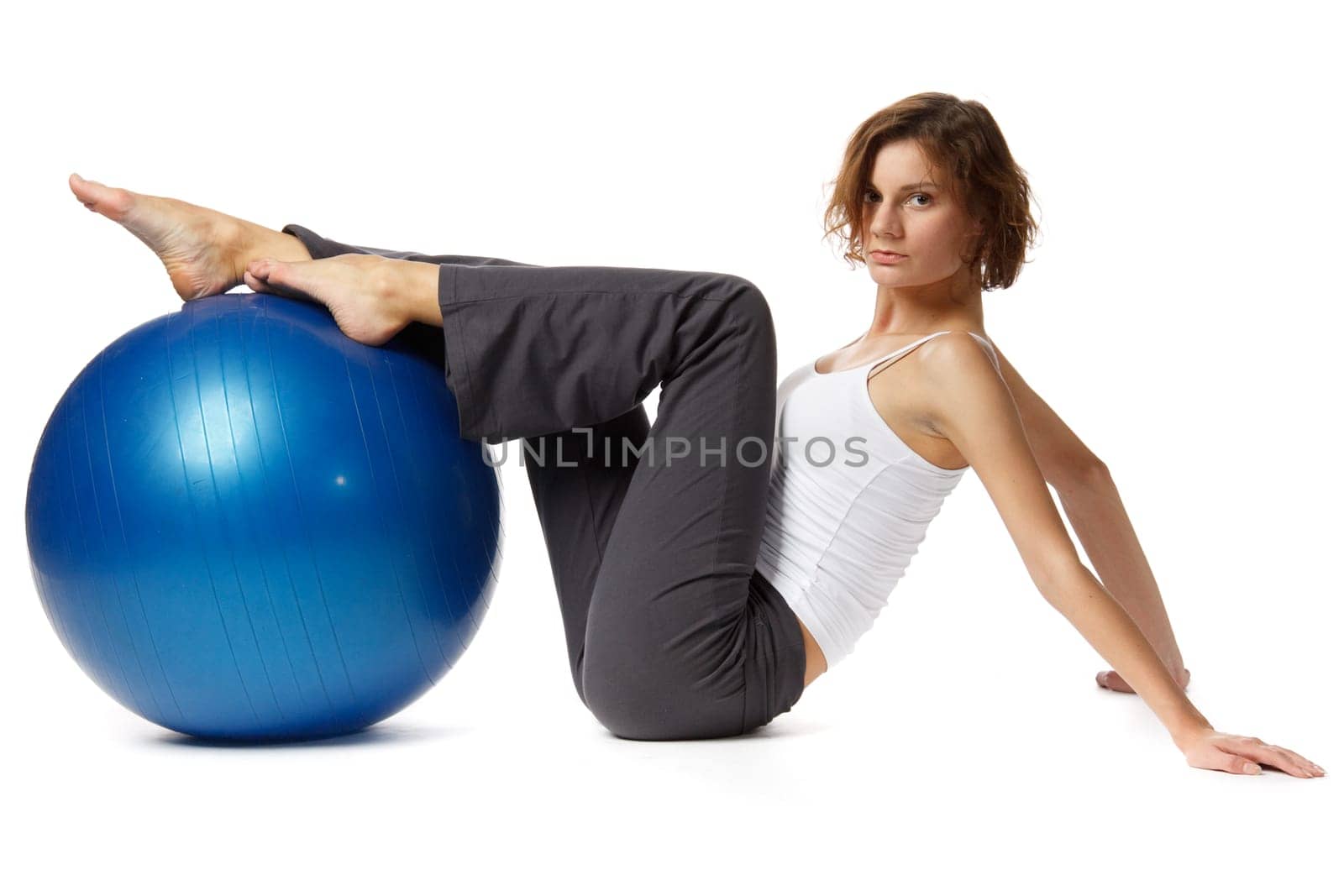 Young  beautiful woman with gymnastic ball on a white background.