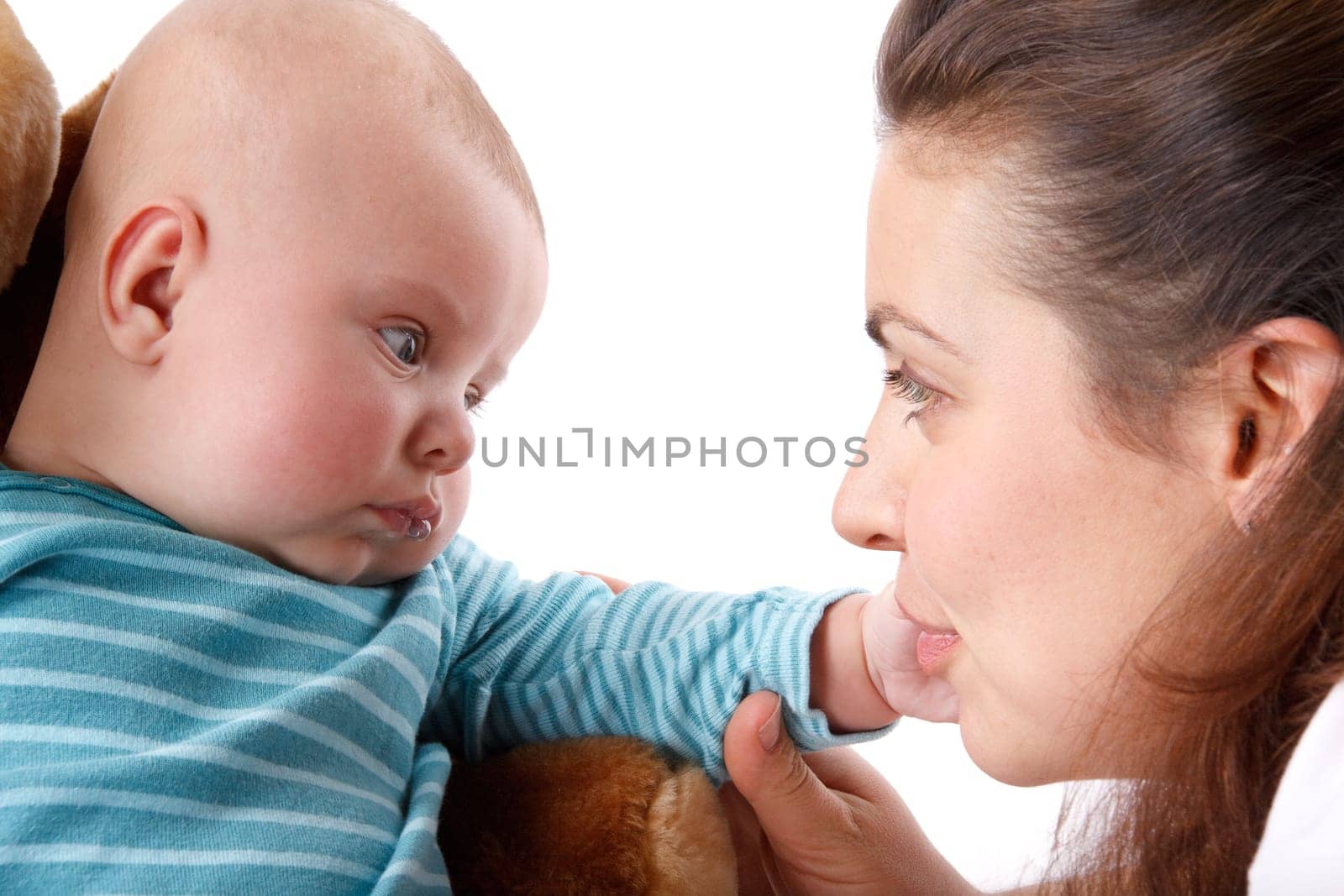 Happy mum plays with the small child a white background.