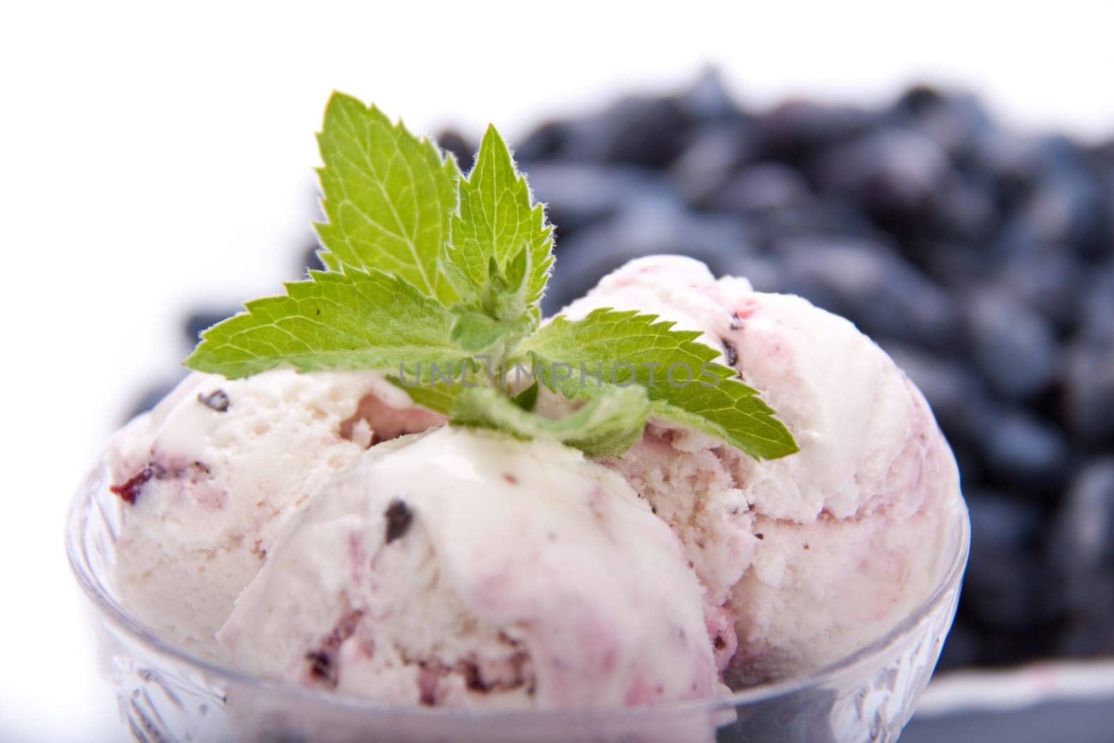 Ice-cream with fresh berries of a honeysuckle on a white background.