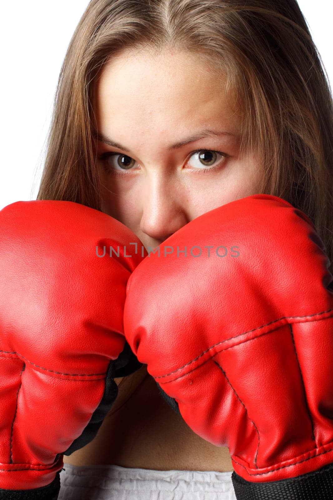 Sporty girl in red fighting gloves on a white background.