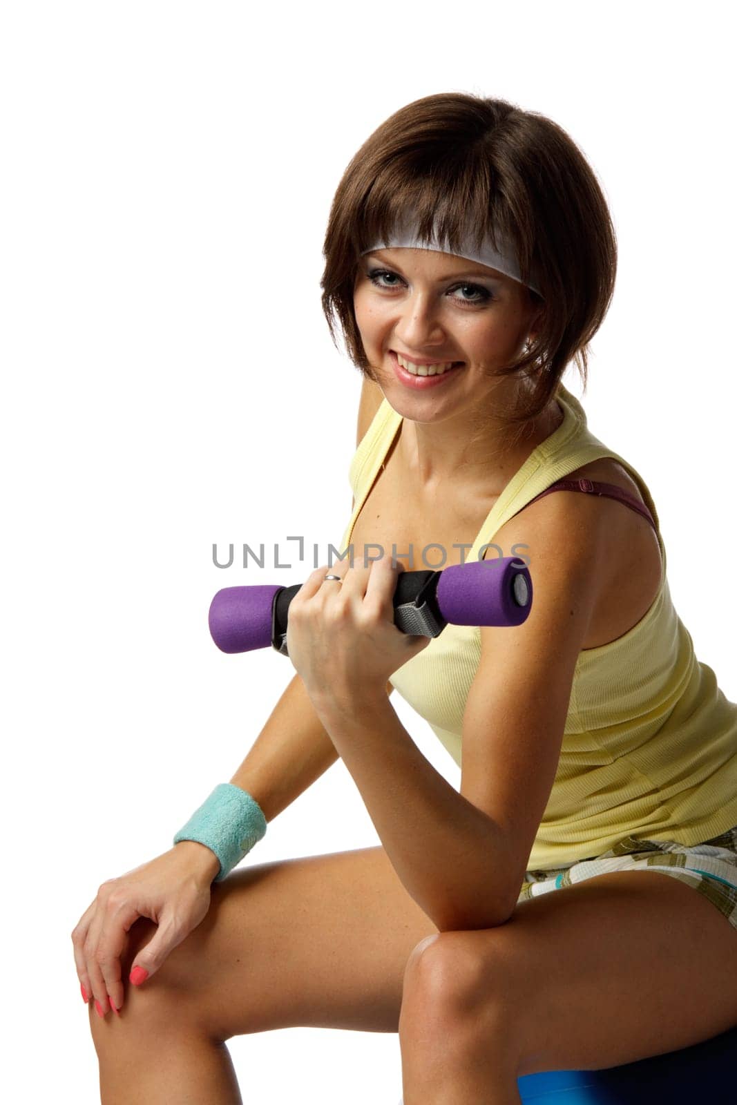 The beautiful sports girl with dumbbells on a white background. Training.