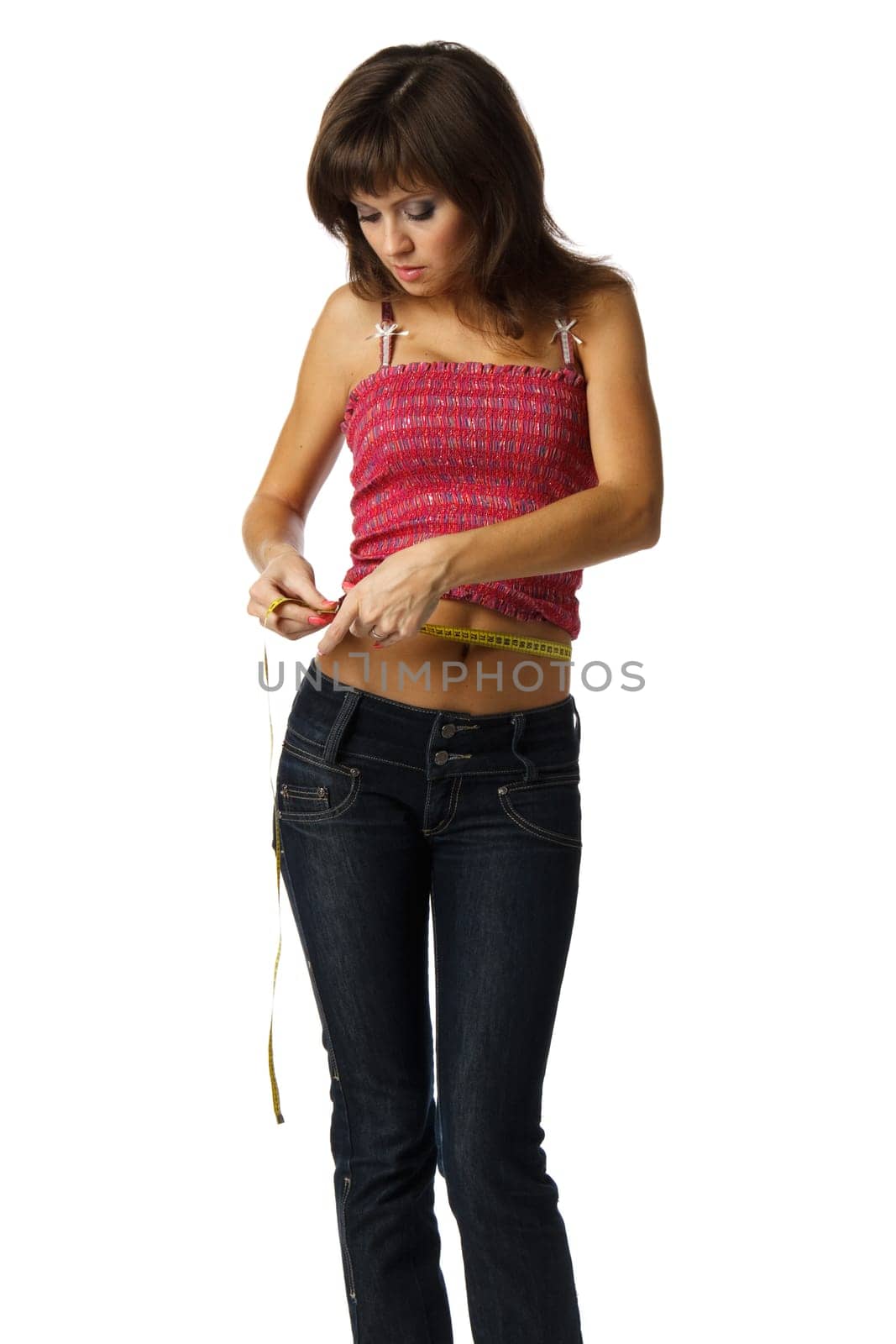 The beautiful girl measures a waist on a white background. Healthy lifestyles concept.