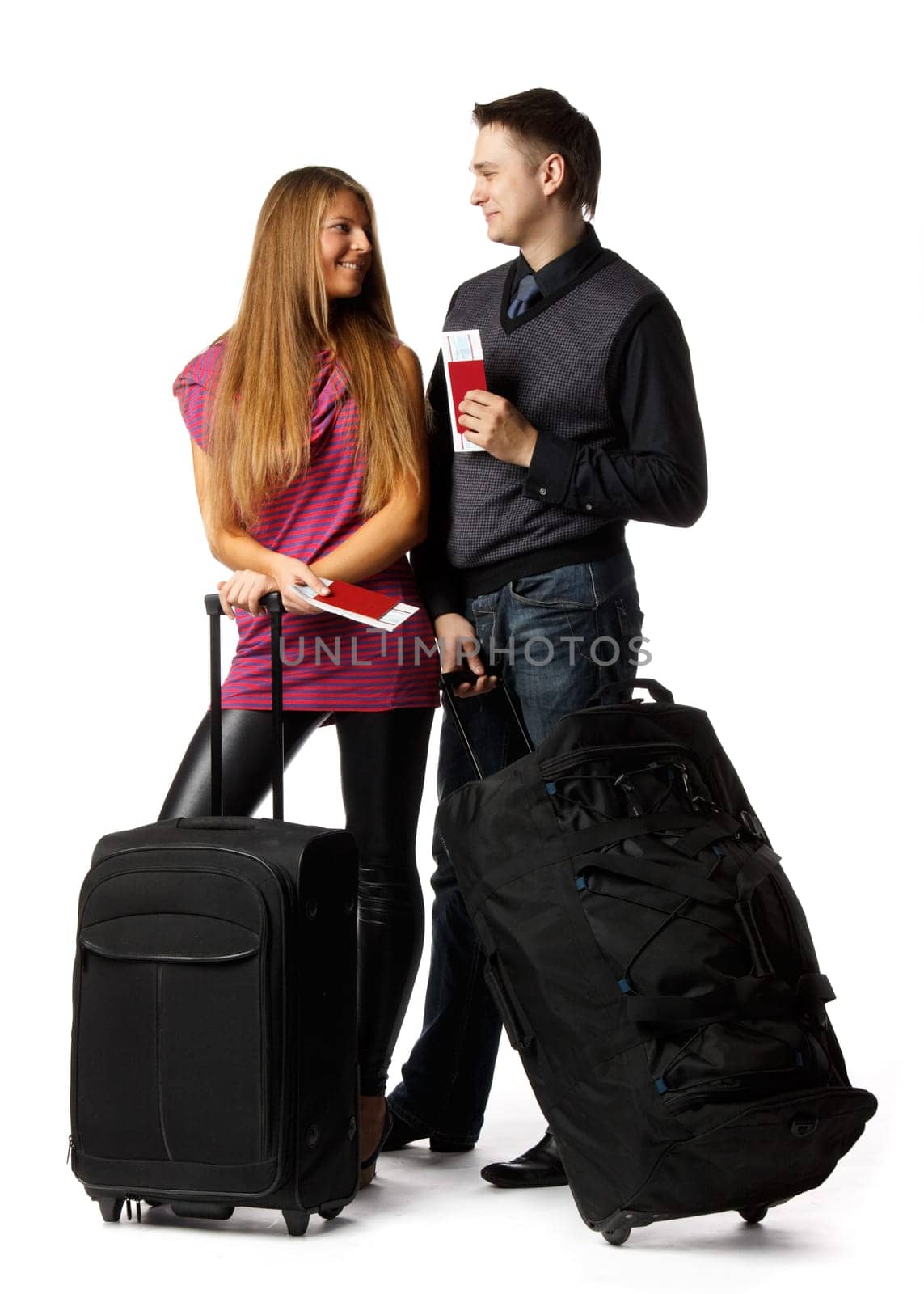 Happy young family with suitcases and tickets on a white background. Vacation.