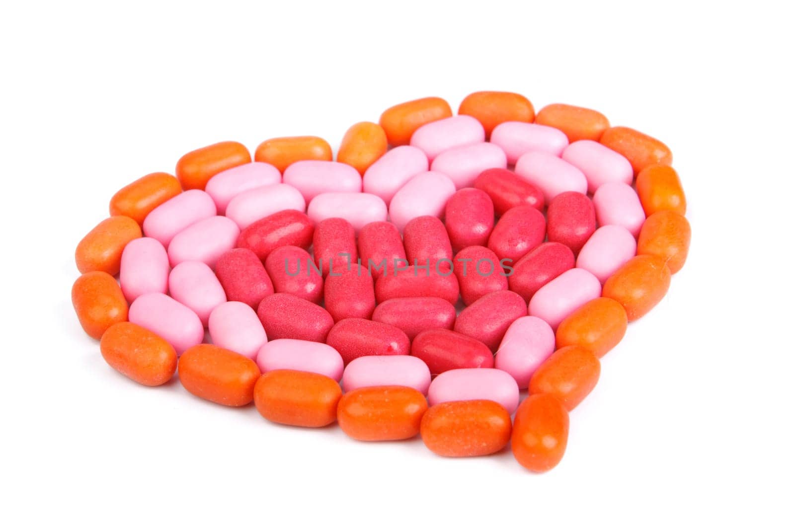 Heart from candies on a white background