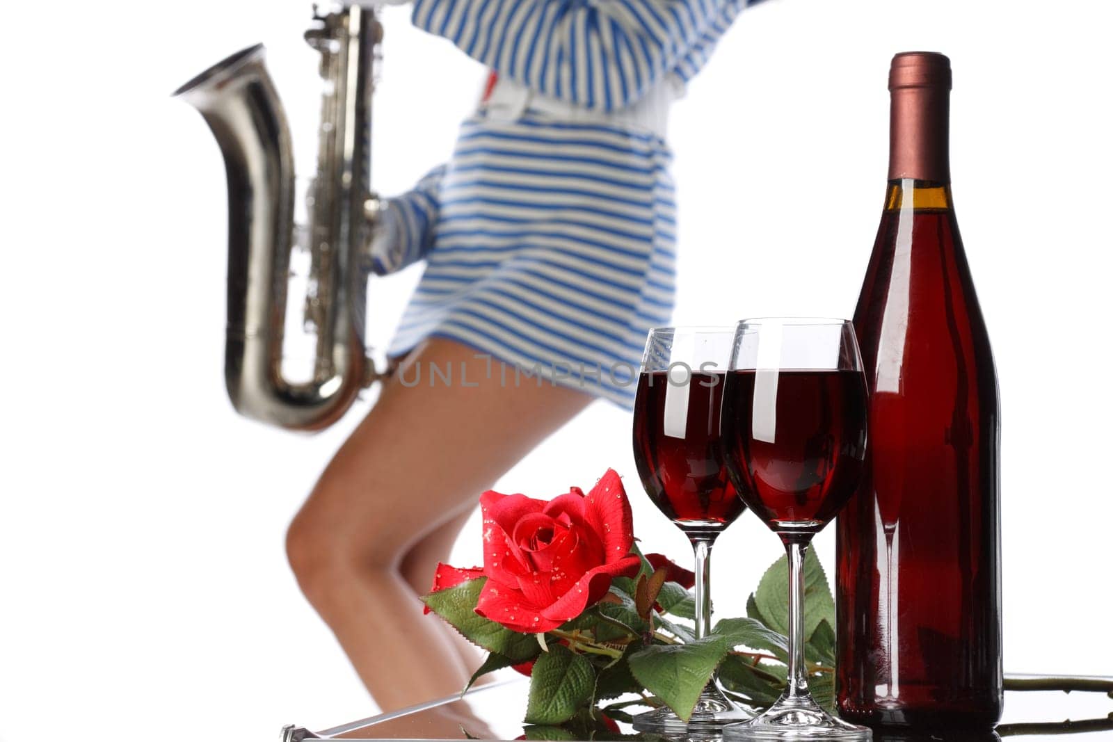The wine bottle, two glasses, rose and the sexual girl with a saxophone.