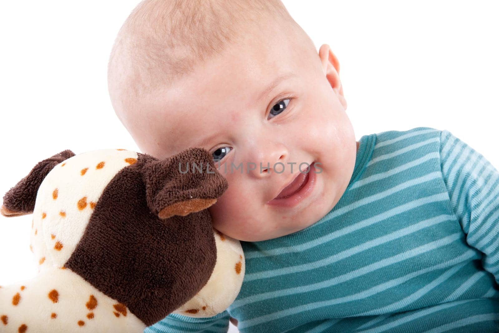 The nice small child in striped rompers with toy on a white background.