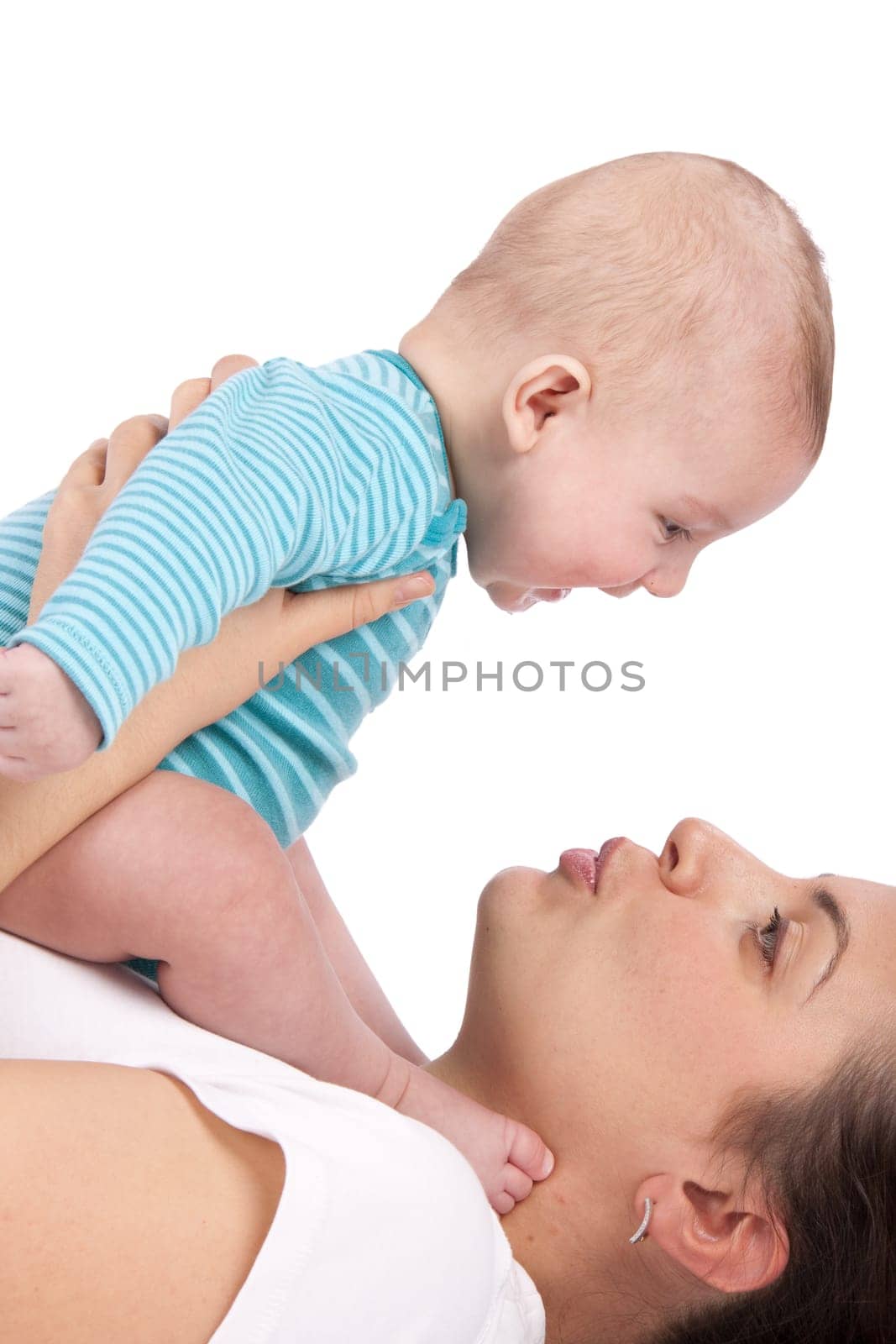 Happy mum plays with the small child a white background.