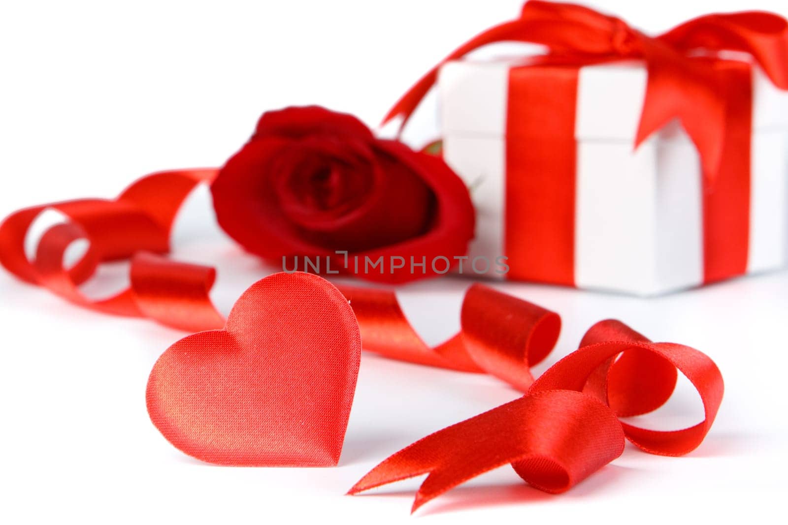 Gift box and rose on a white background. Valentine&#039 s day card.