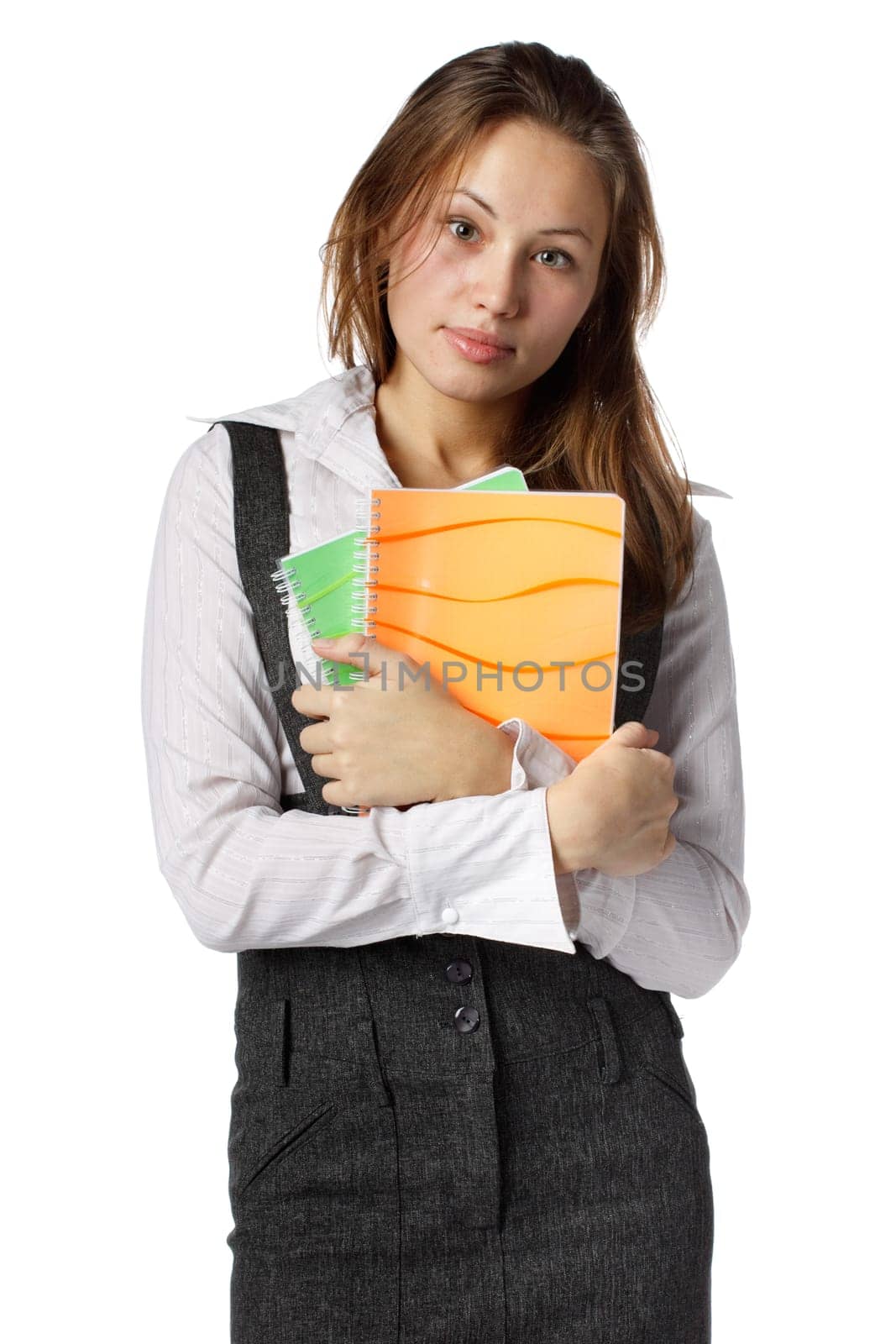 The beautiful girl stand with coloured writing-books on a white background. The student.