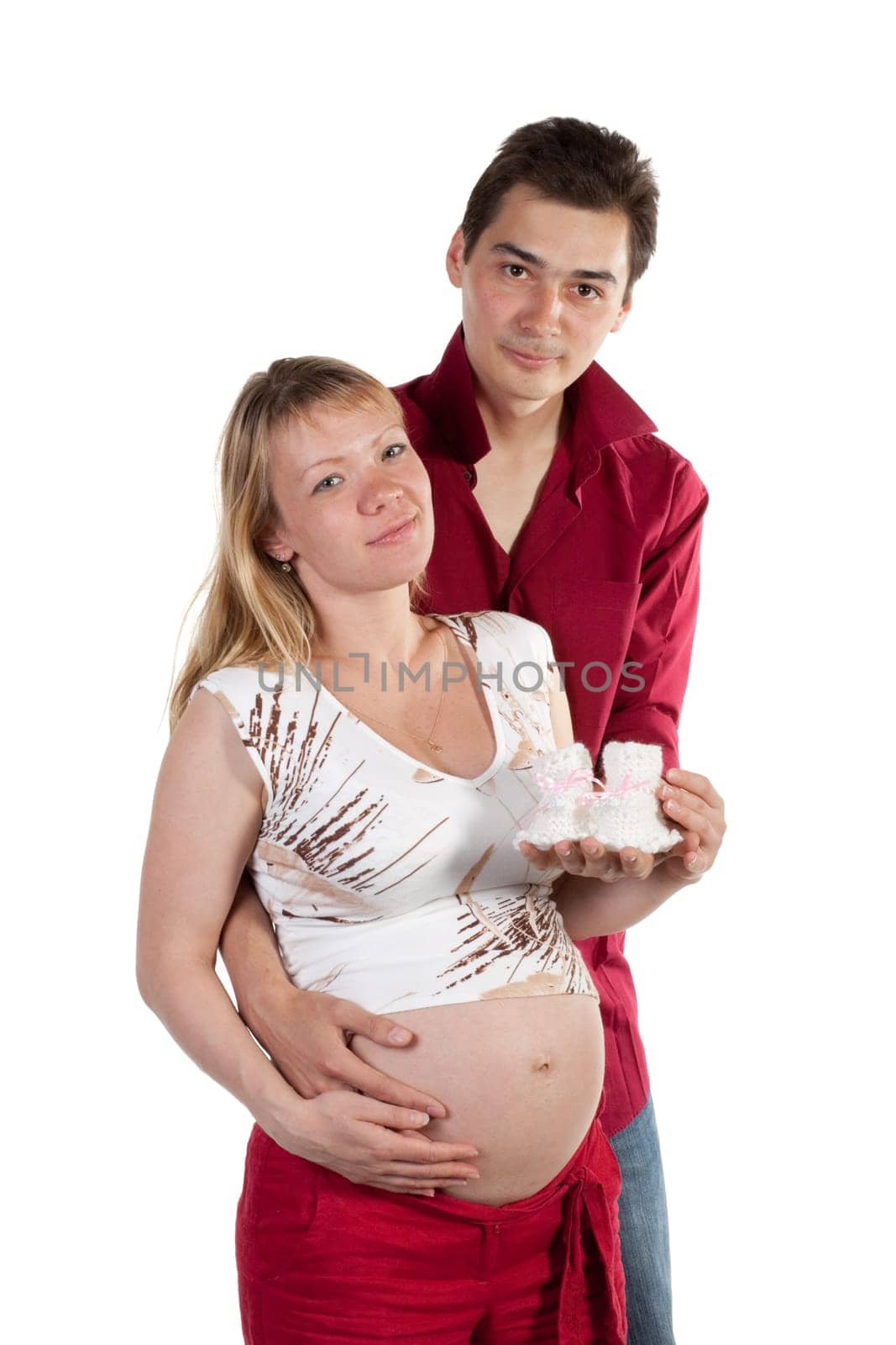 The young family expecting a birth of the child, holds bootees
