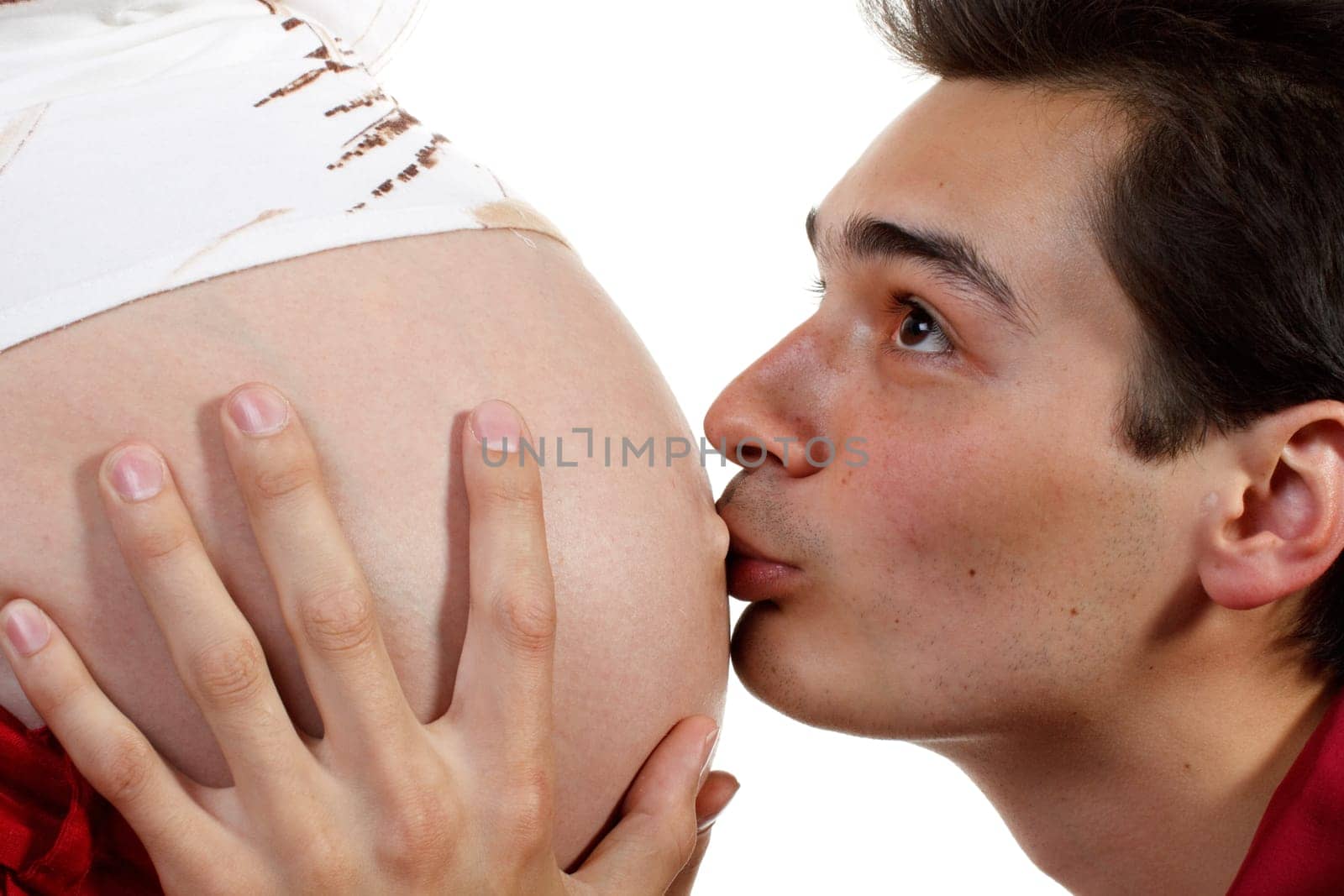 The happy father kisses a stomach of the pregnant wife