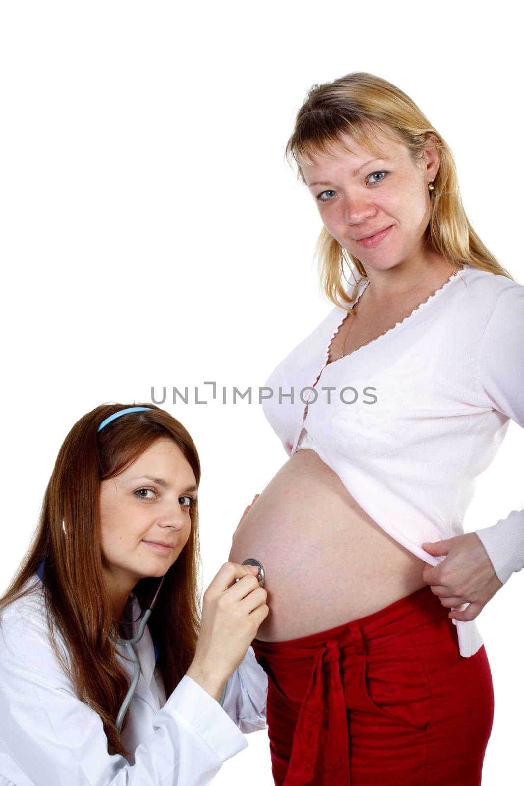 Pregnant woman being examined by doctor on a white background