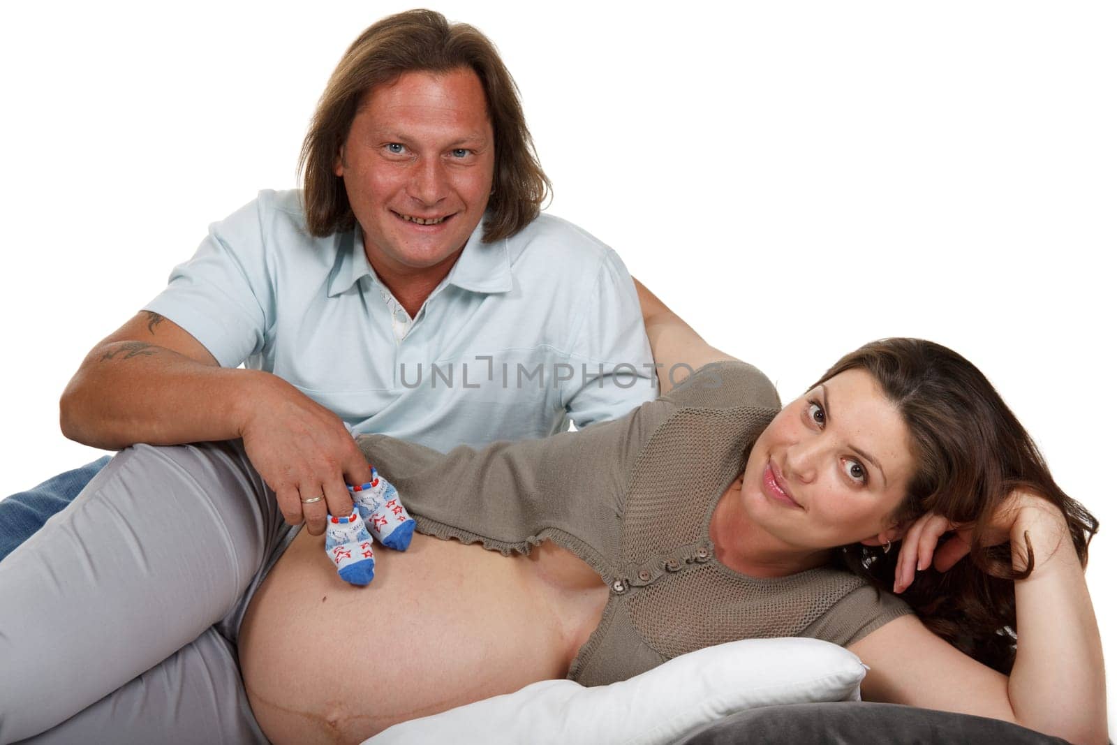 The young family expecting a birth of the child, holds bootees