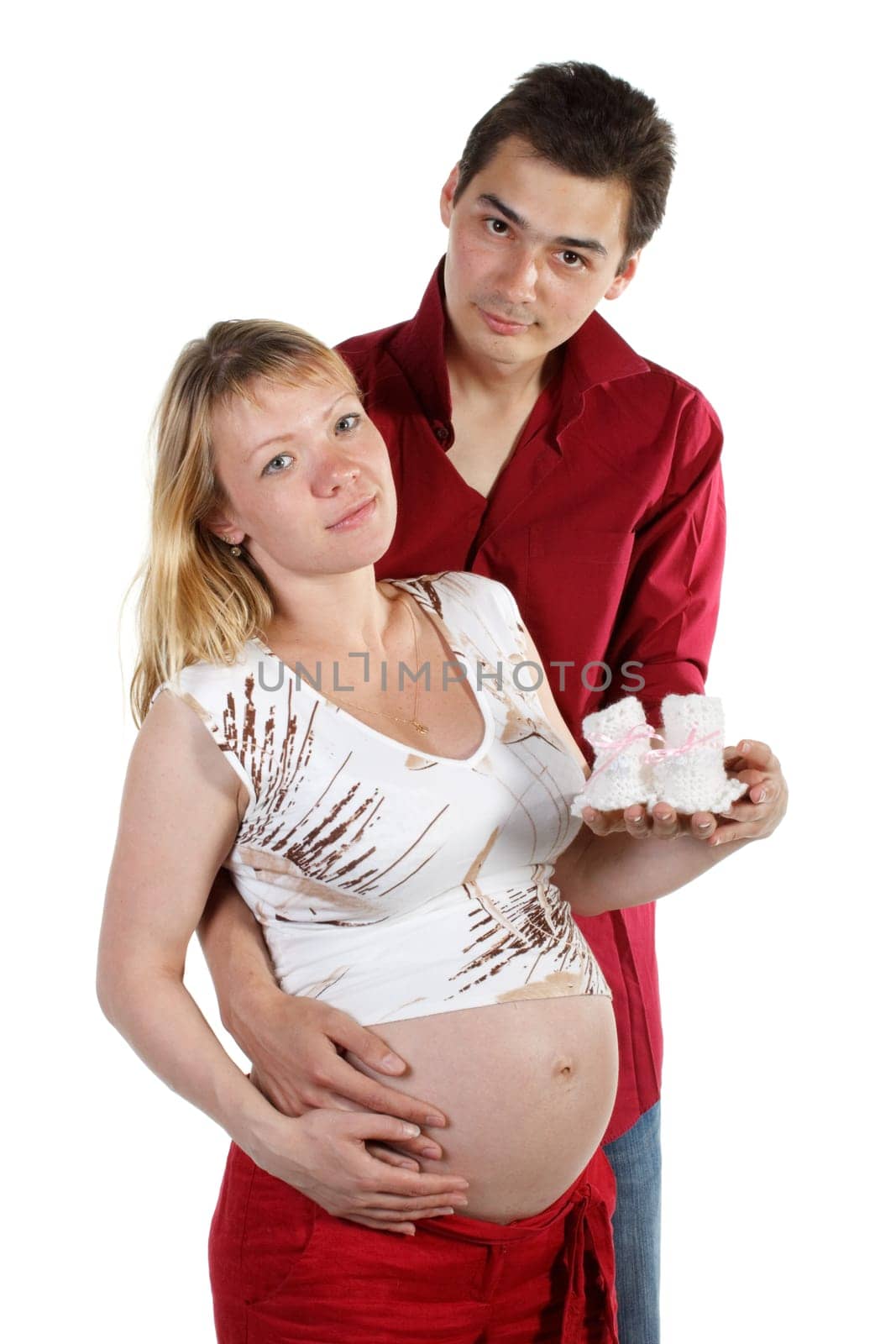 The young family expecting a birth of the child, holds bootees