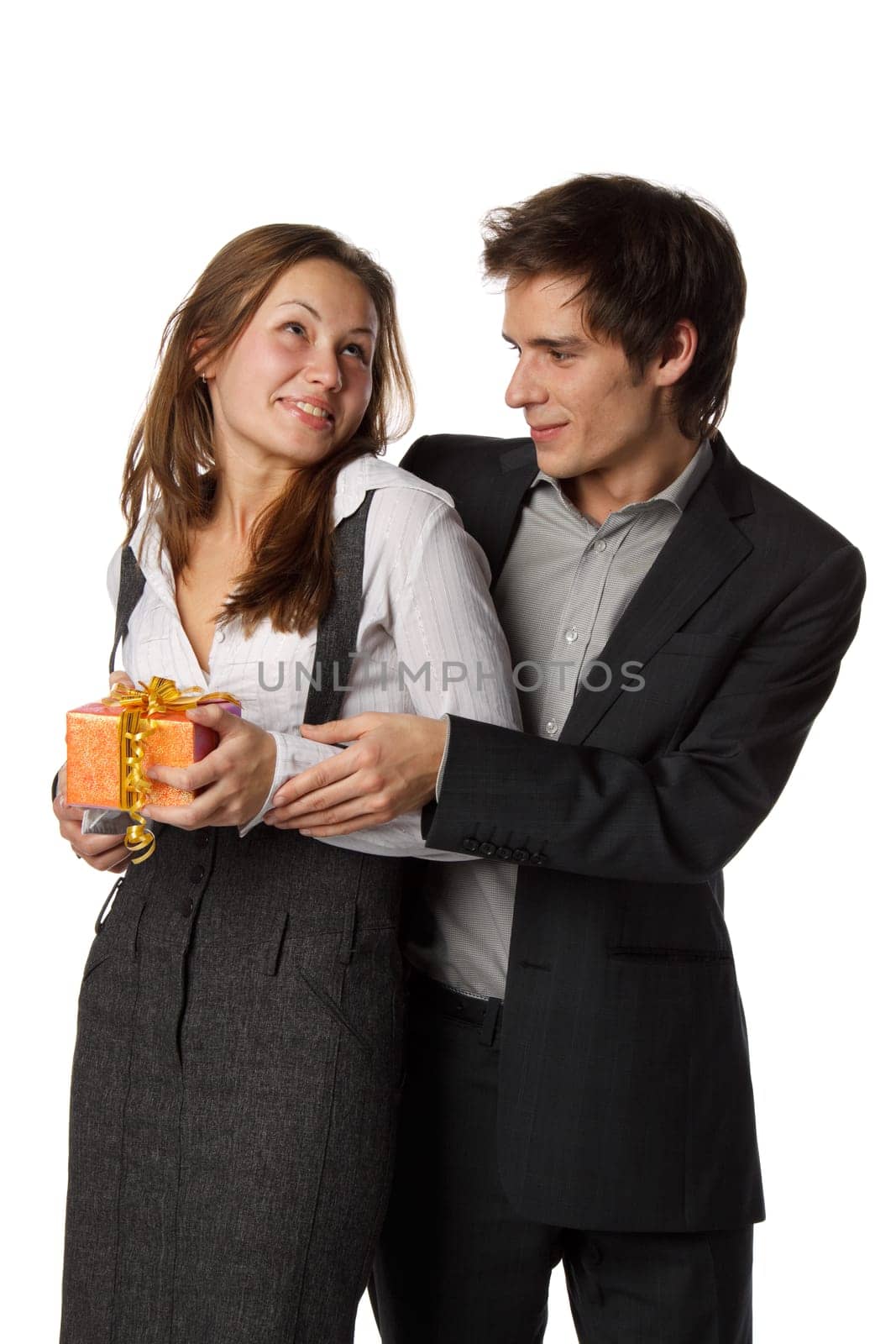 The young enamoured man gives a gift to the girlfriend on a white background.