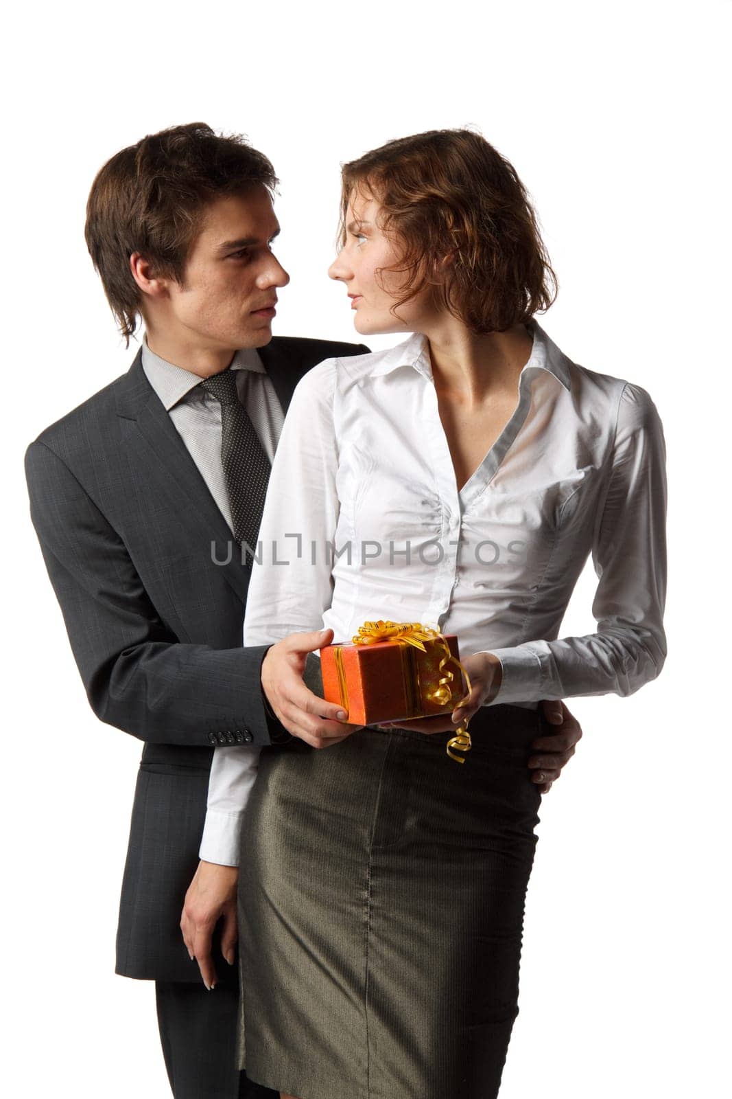 The young enamoured man gives a gift to the girlfriend on a white background.