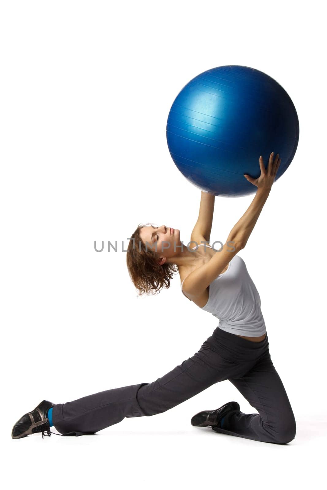Young beautiful woman with gymnastic ball on a white background.