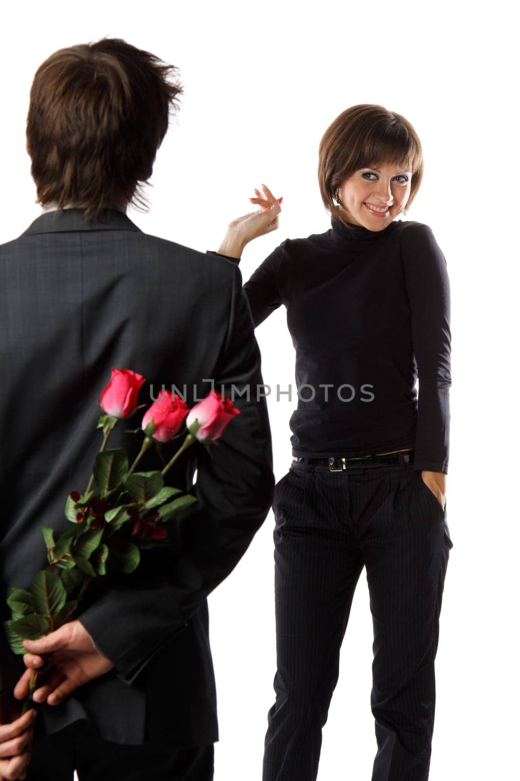 The young enamoured man with flowers and his girlfriend on a white background.