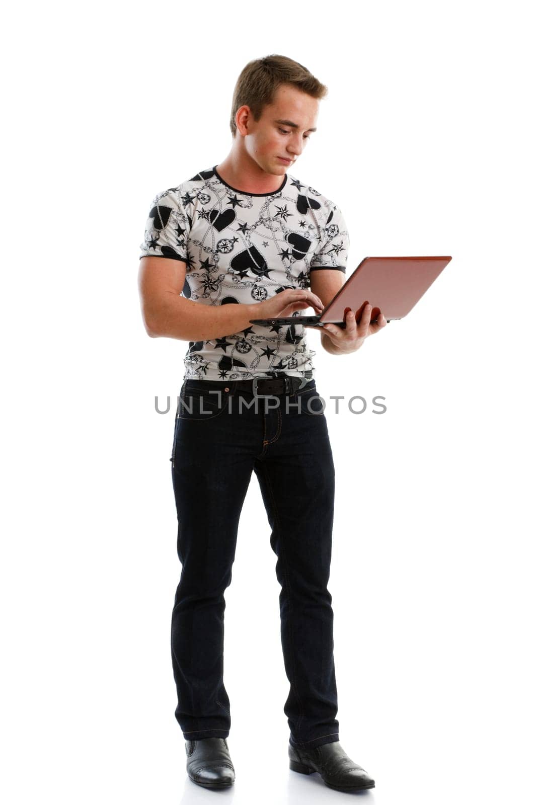 Student stands with the laptop on a white background.