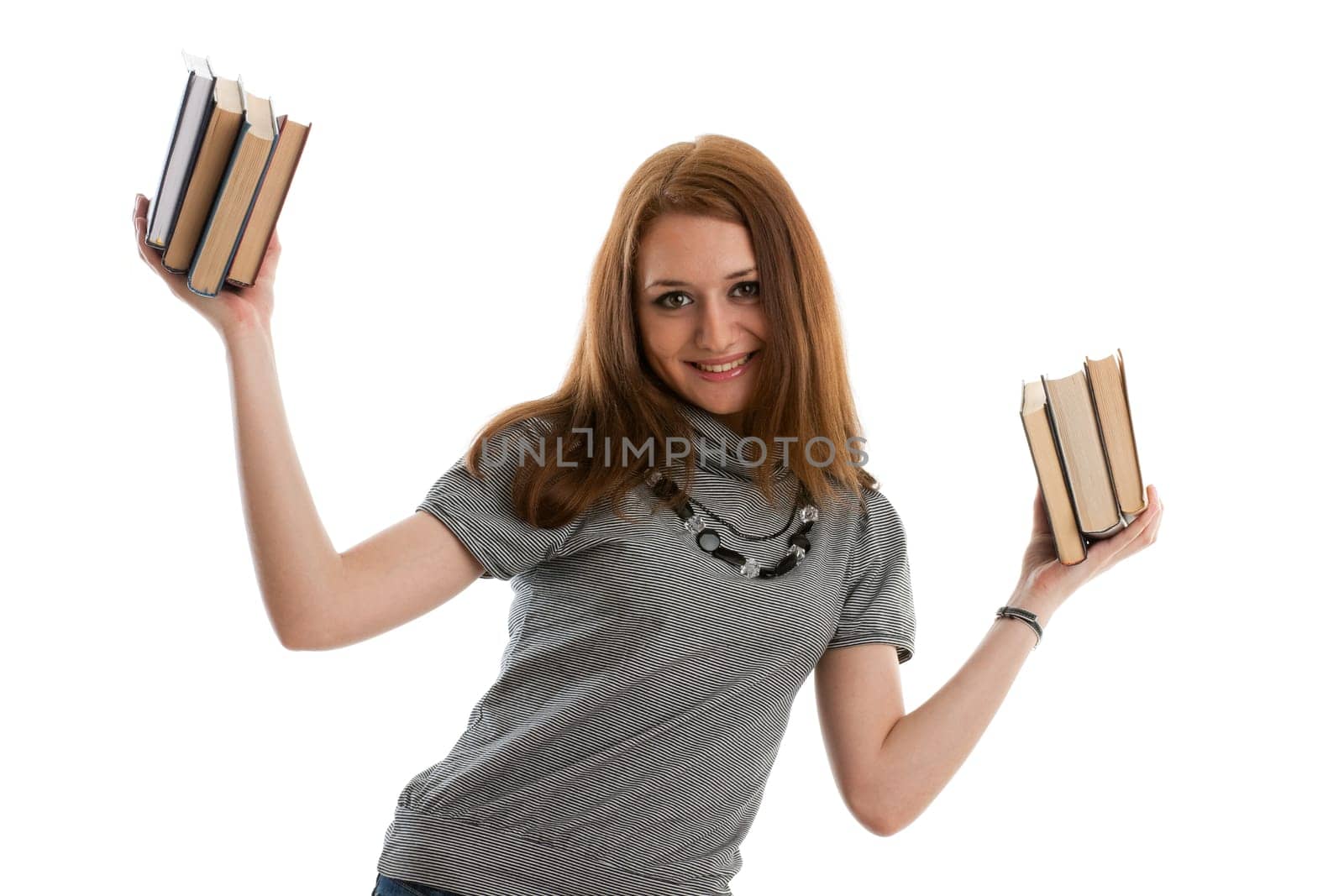 The attractive student stands with books on a white background. The student.