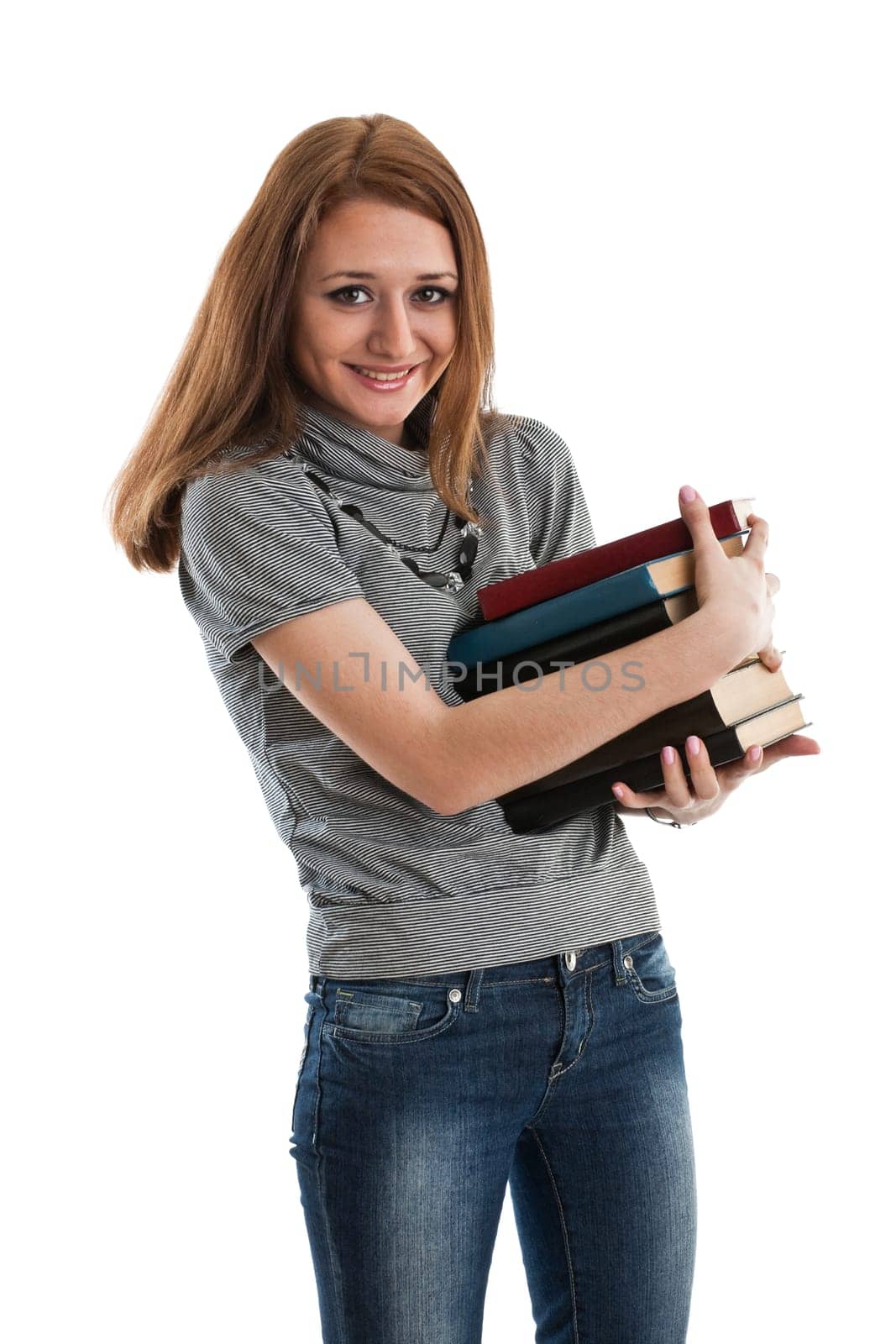 The attractive student stands with books on a white background. The student.