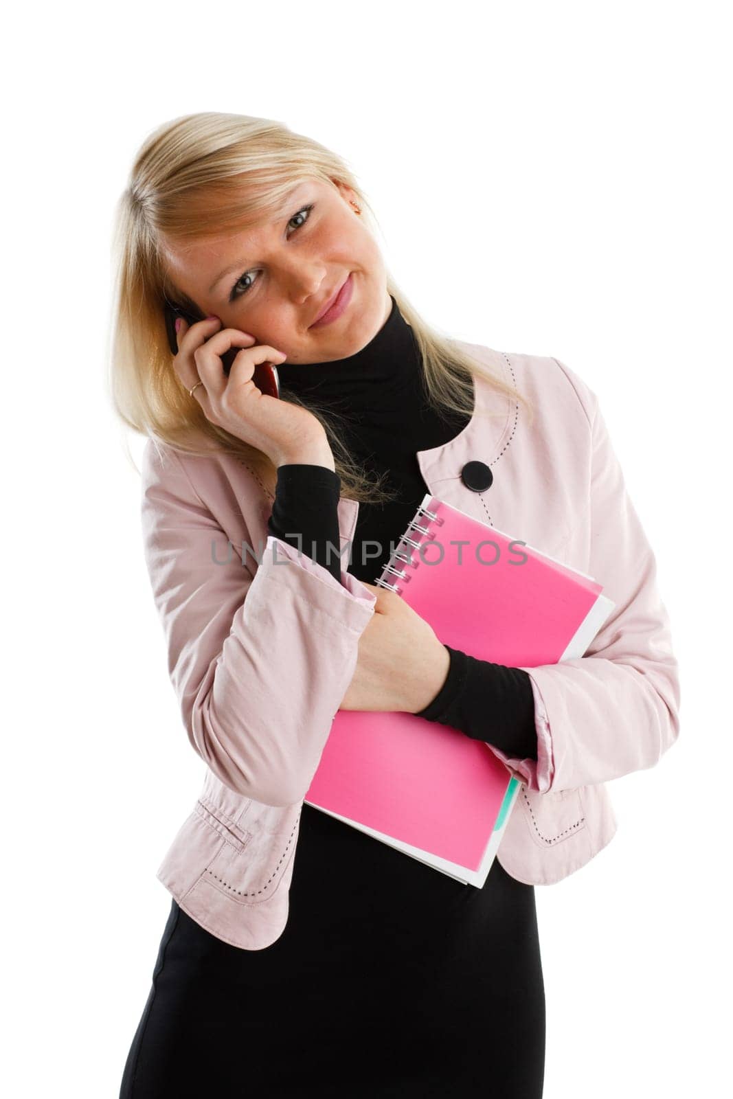 The beautiful girl stand with writing-books and mobile phone on a white background. The student.
