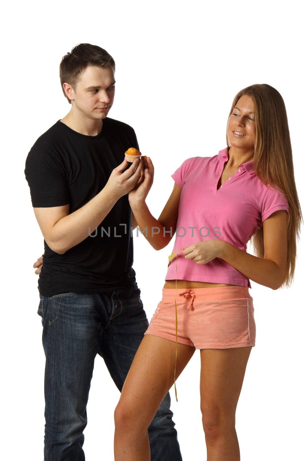 The young man offers delicious cake to the girl on a white background. Healthy food concept.