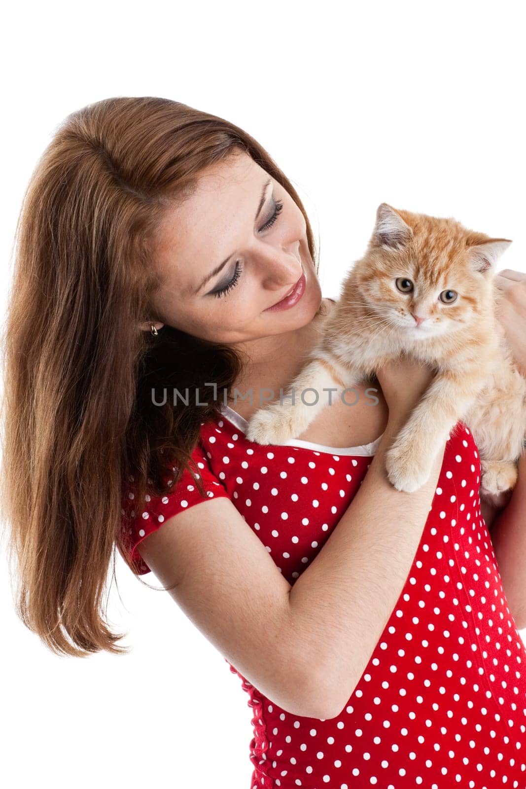 The happy young woman with a small amusing kitten on a white background.